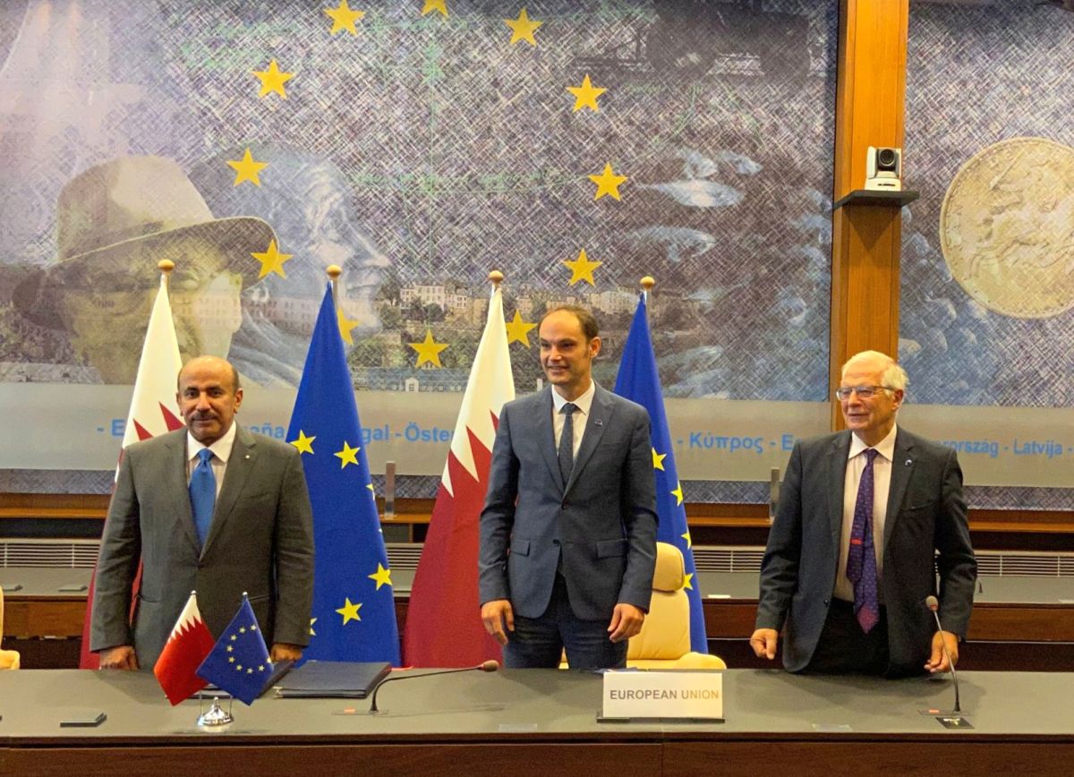 a group of men standing in front of flags