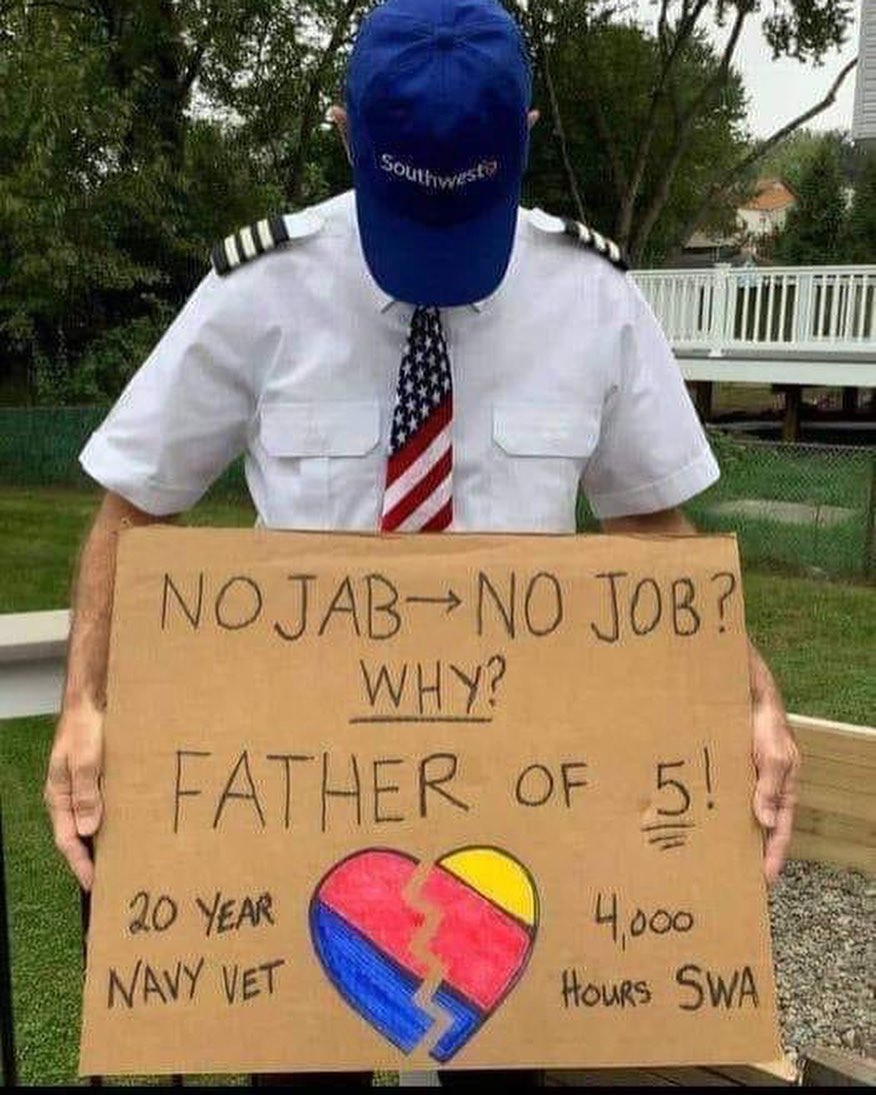 a man in uniform holding a sign