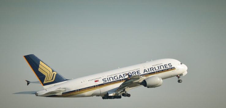 a white airplane flying in the sky