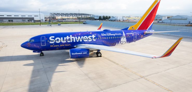 a blue airplane on a runway