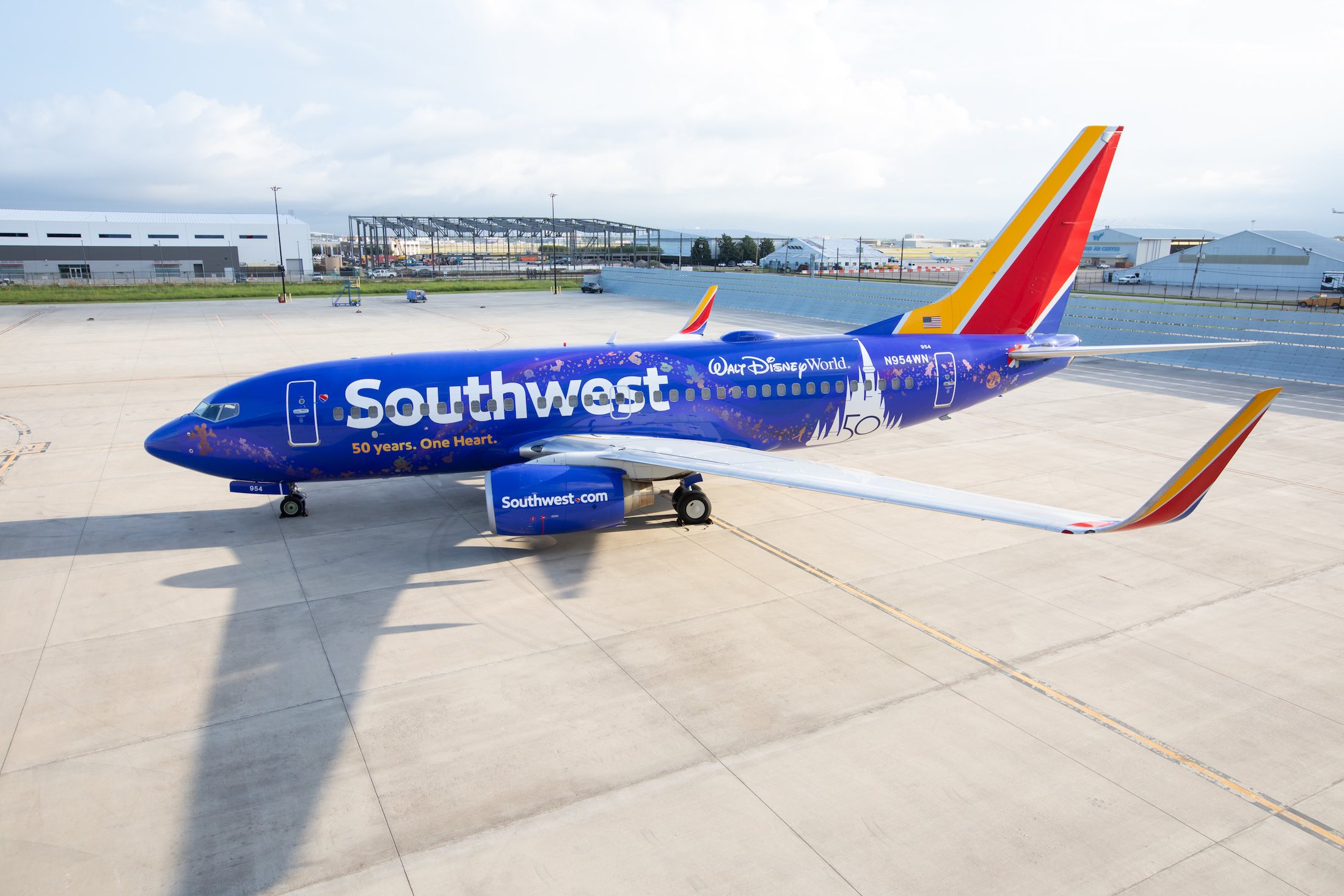 a blue airplane on a runway