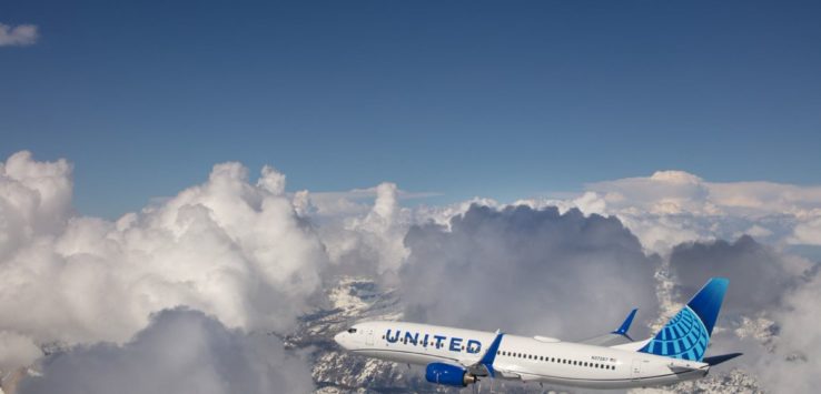 a plane flying over snowy mountains