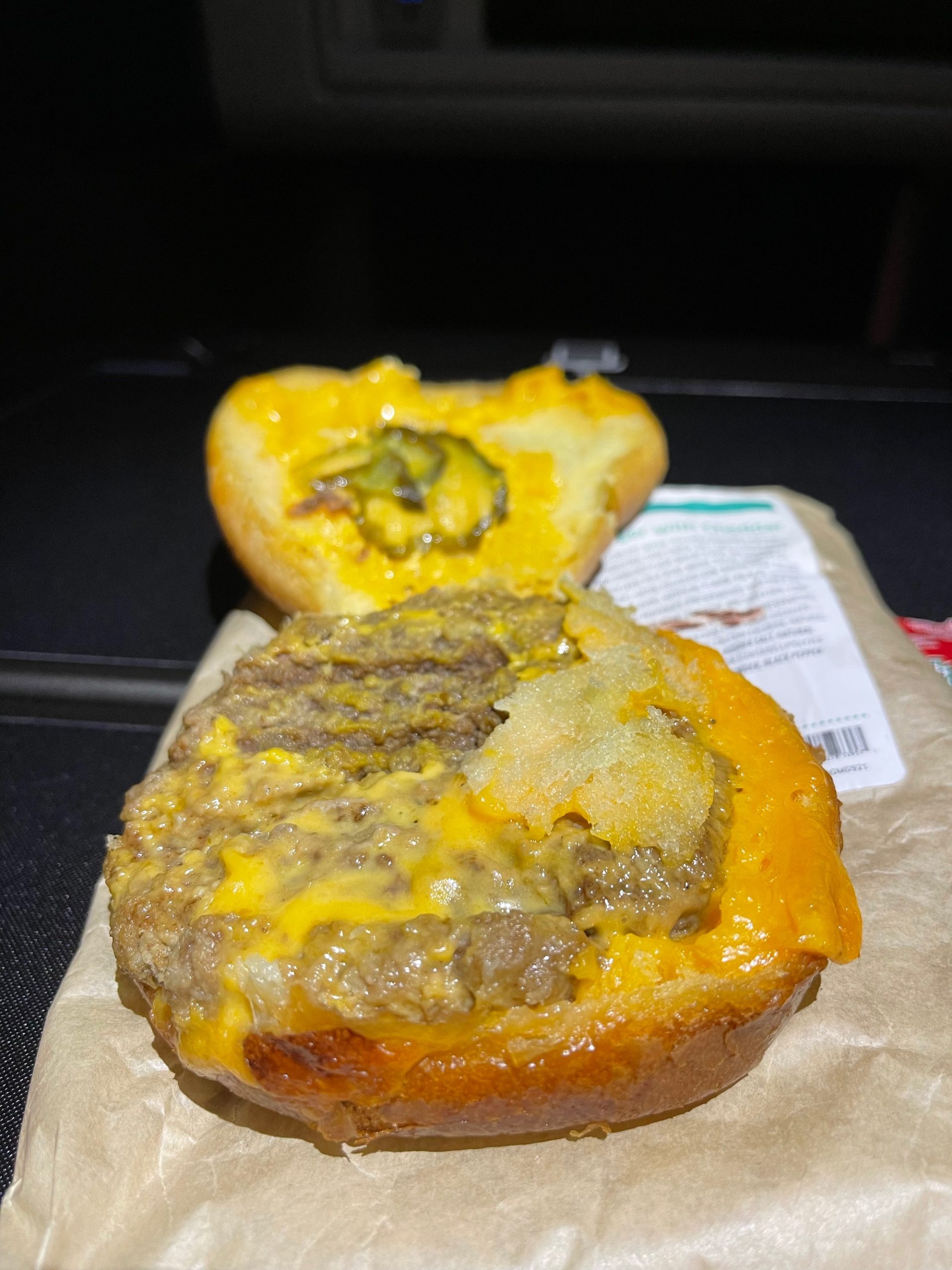 a cheeseburger on a paper bag