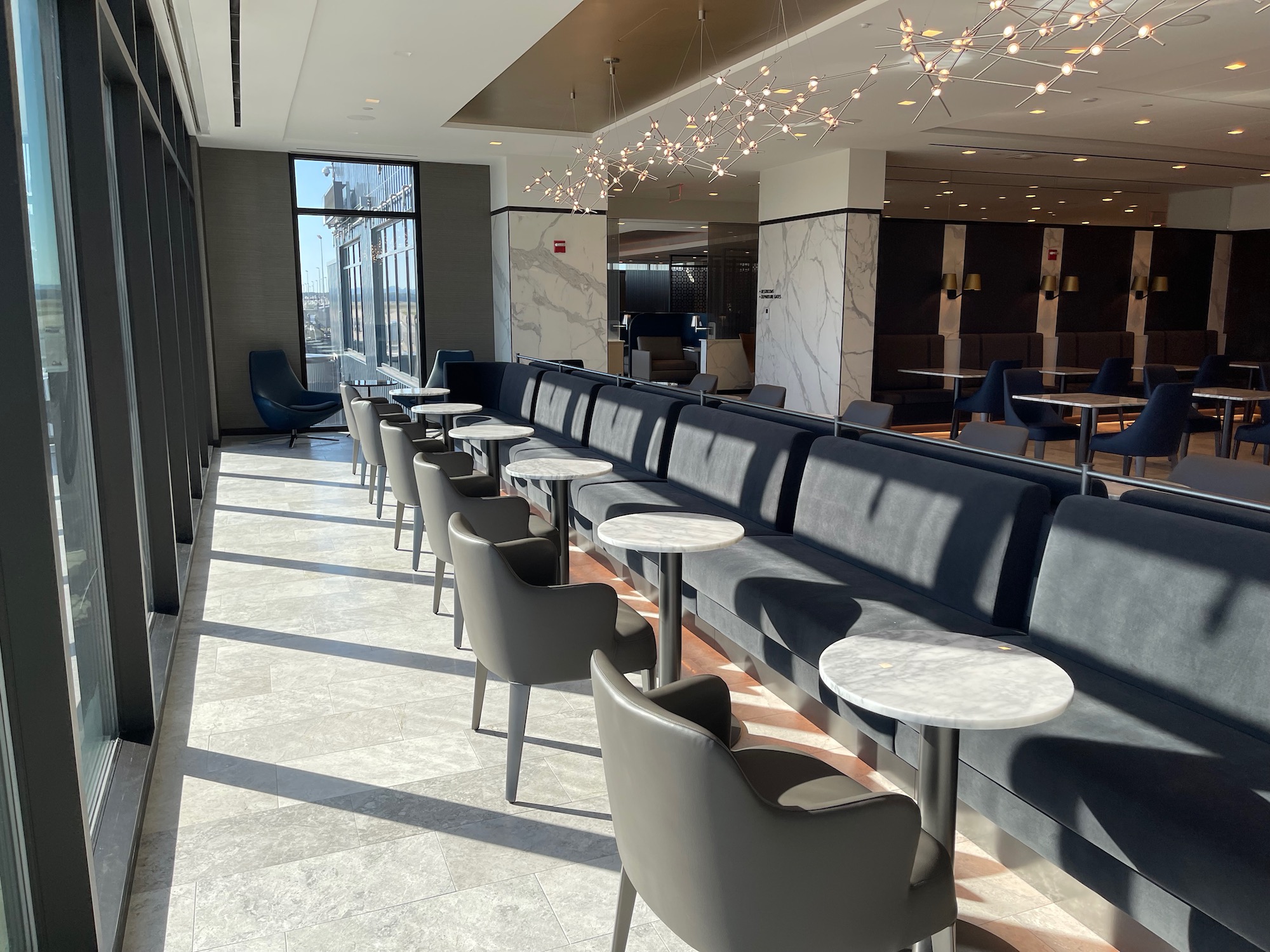 a long row of tables and chairs in a room