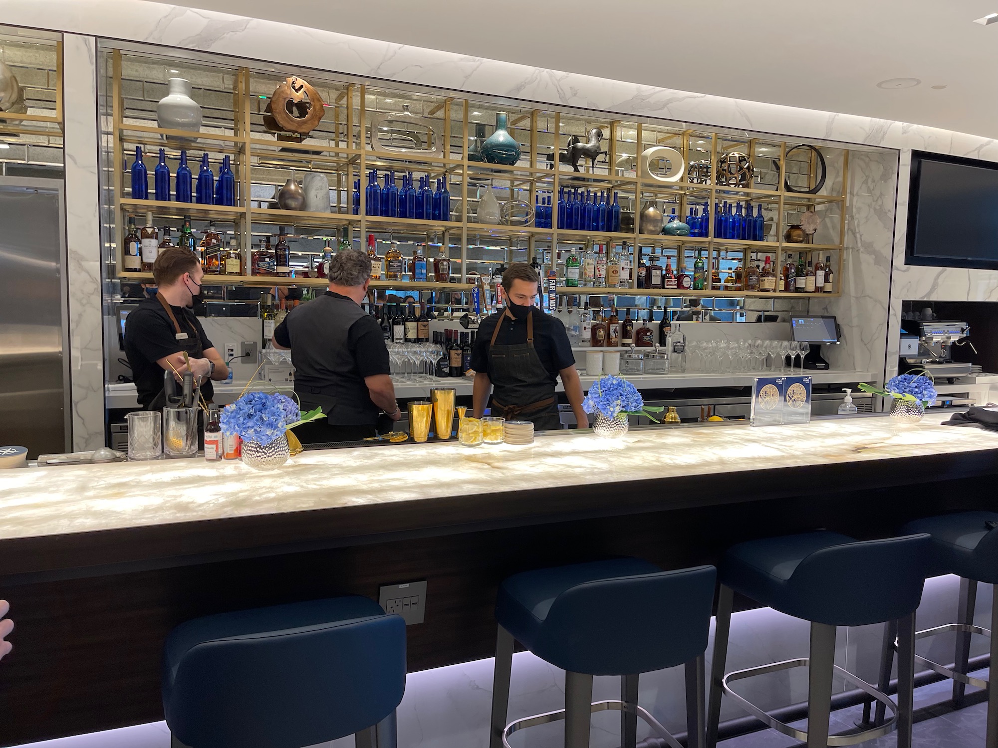 a group of people standing behind a bar