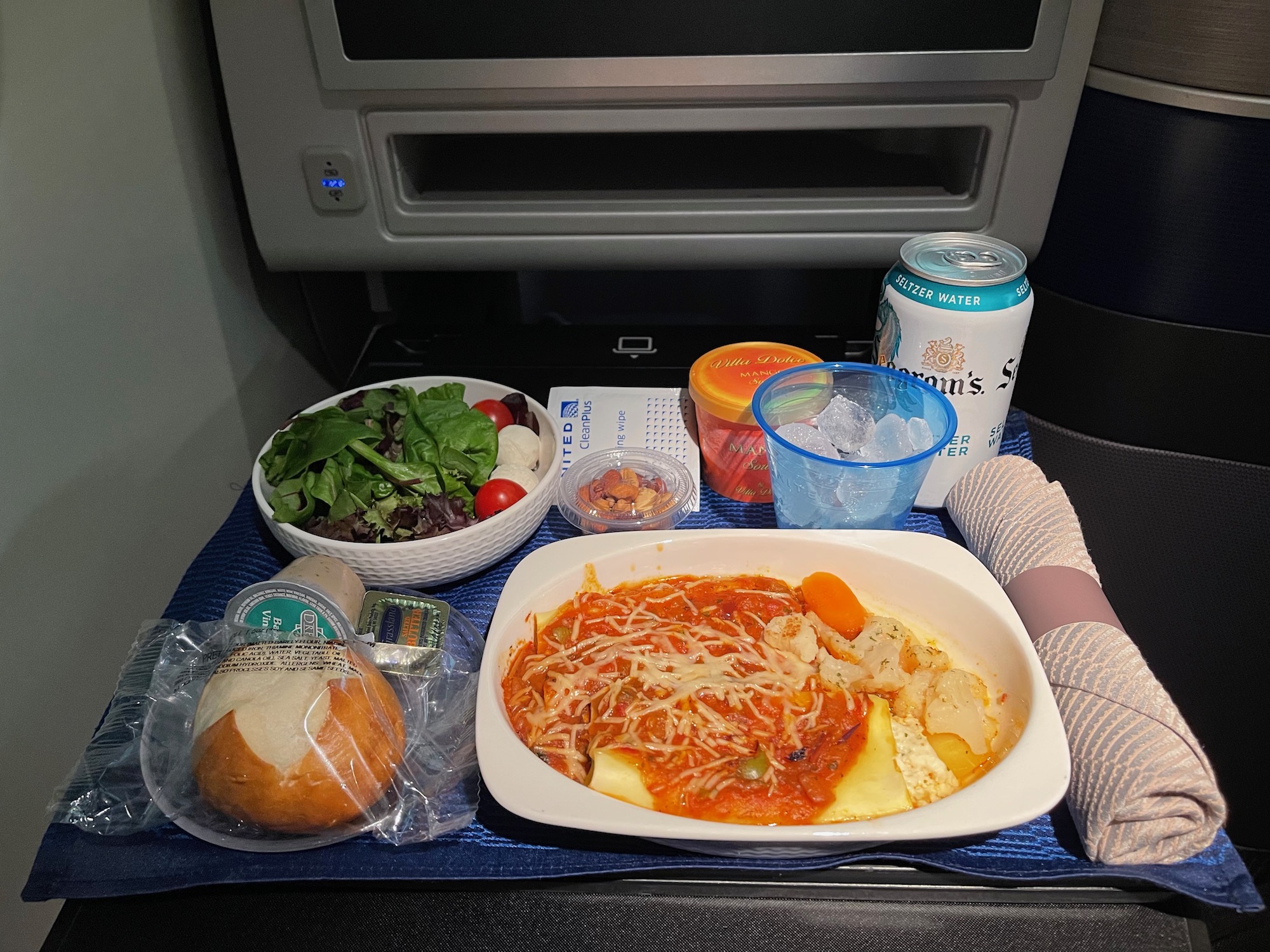 food on a tray in the back of a plane