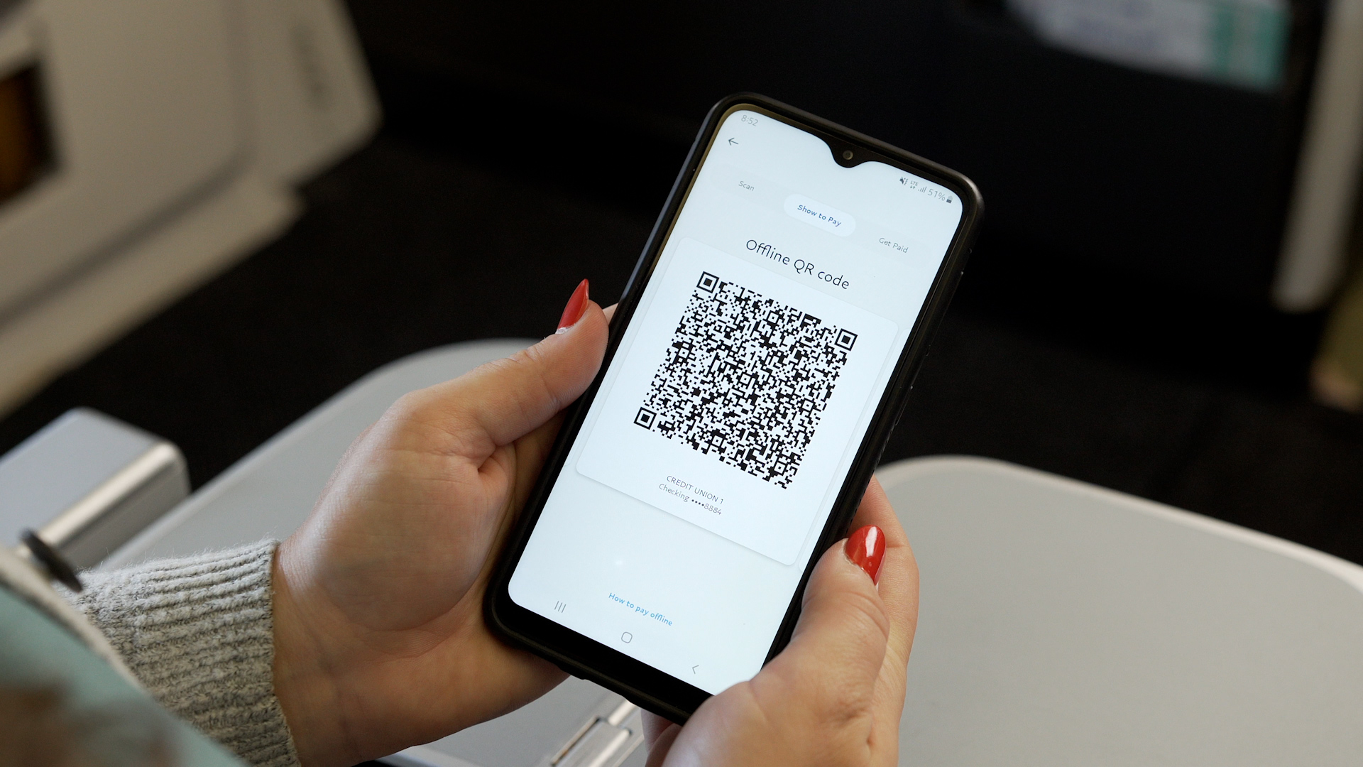 a person holding a phone with a qr code on the screen
