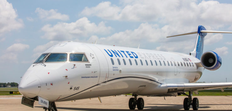 a white airplane on a runway