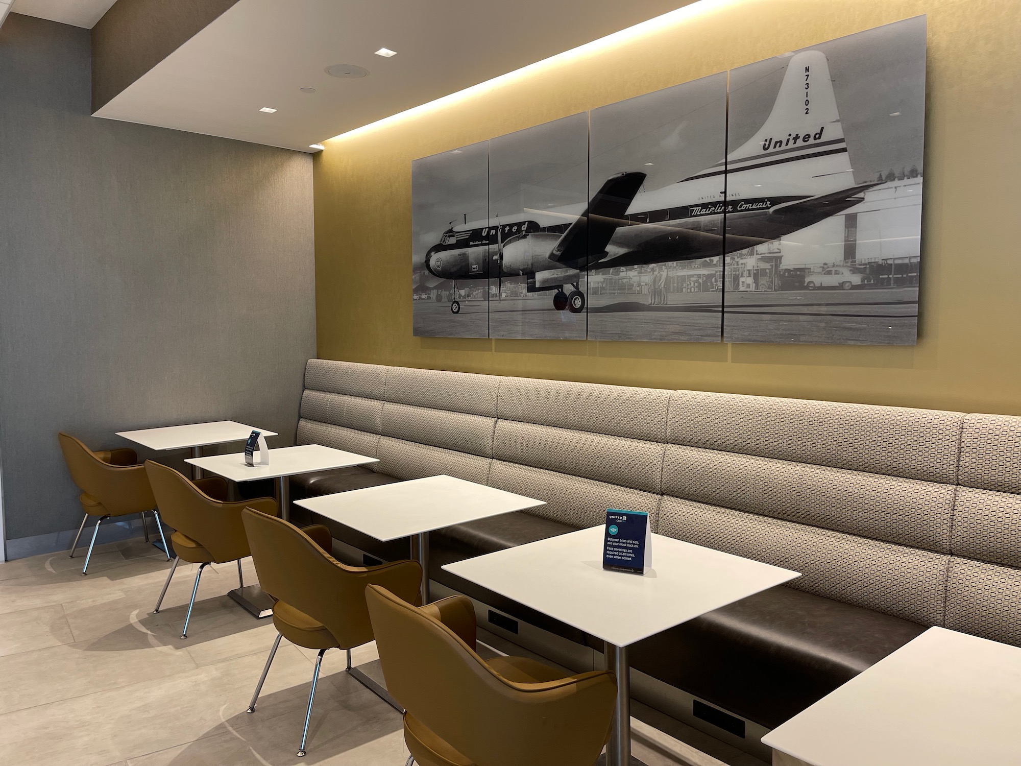 a room with a booth and a picture of an airplane