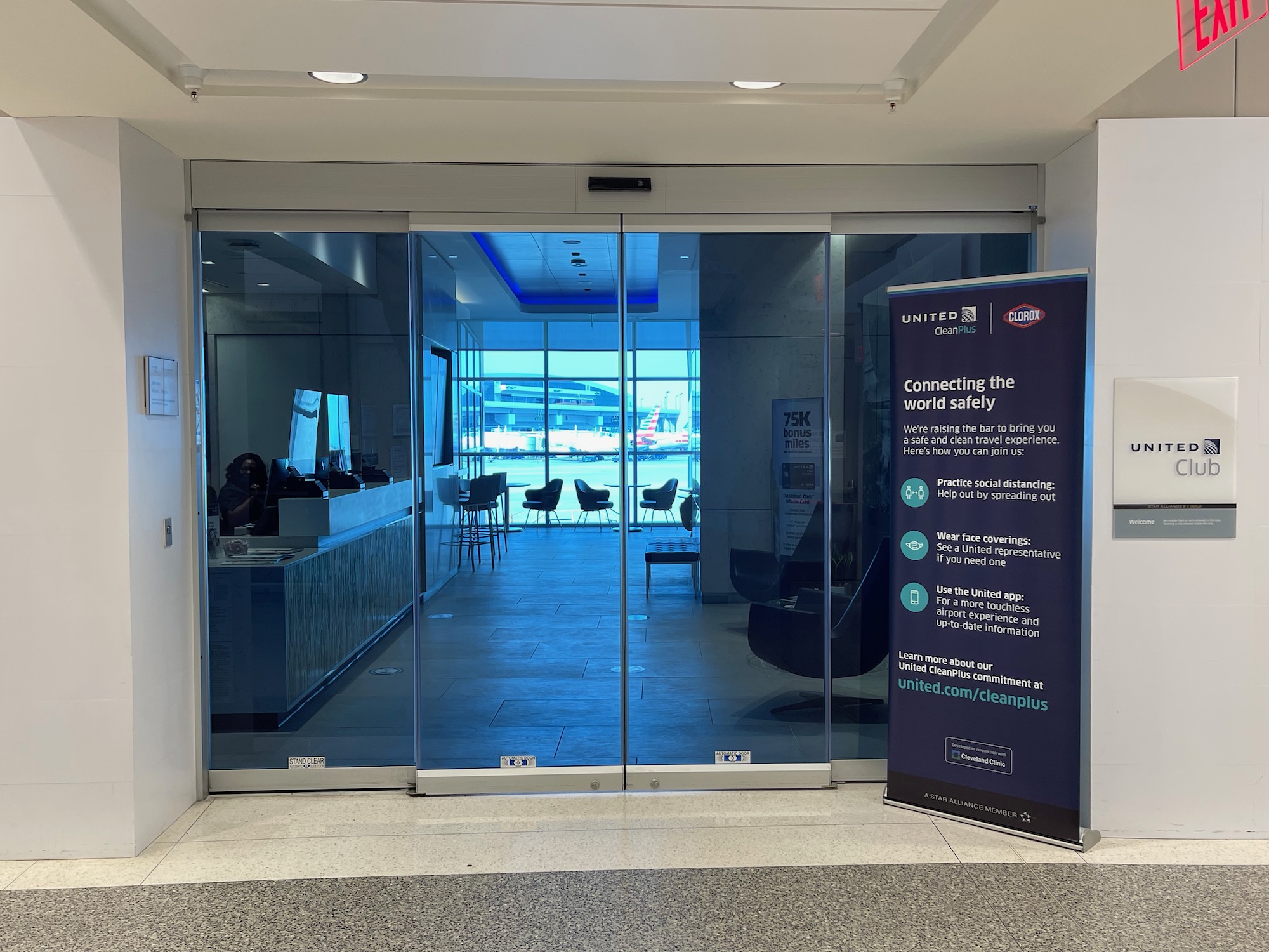 a glass door with a sign in front of it