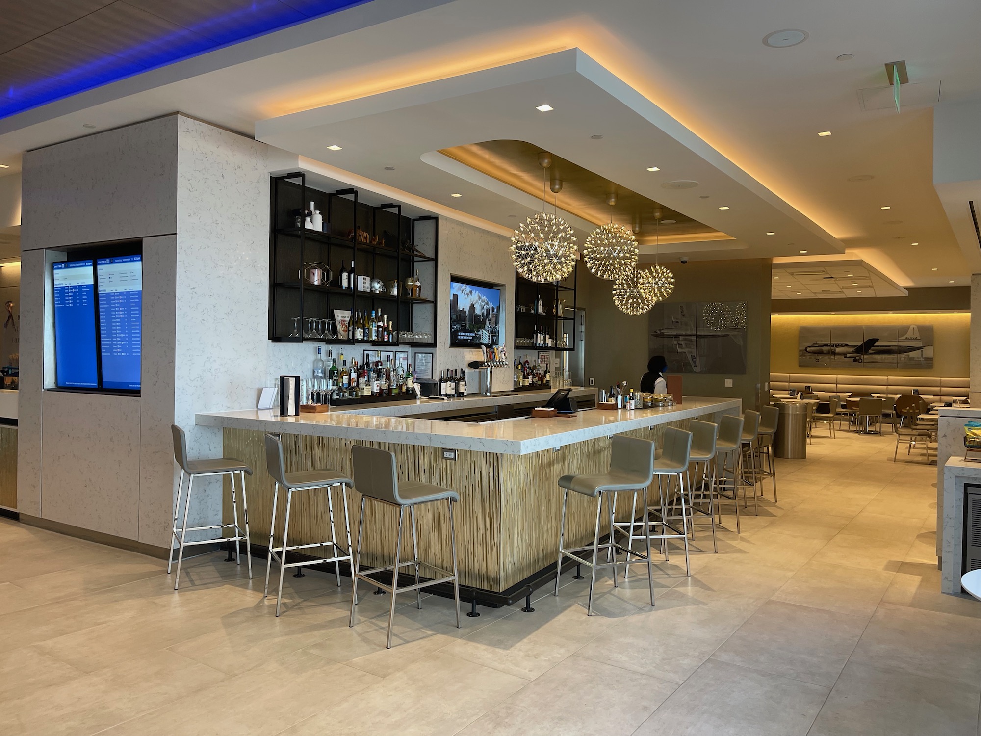 a bar with a counter and chairs