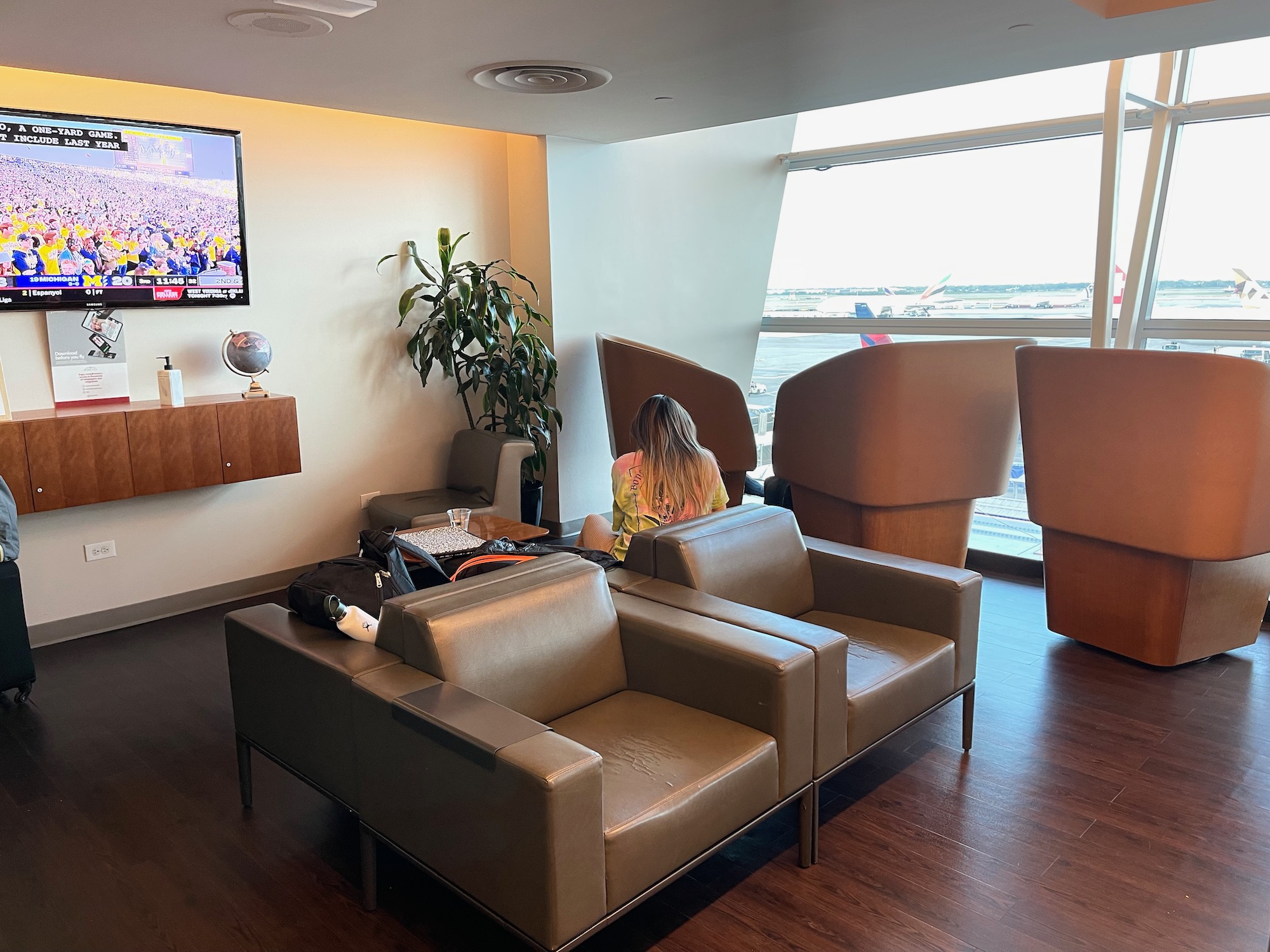 a woman sitting on a couch in a room with a window