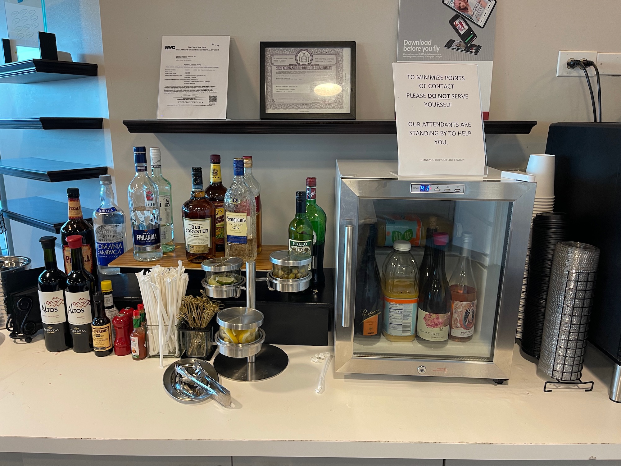 a bar with bottles of alcohol and a glass case