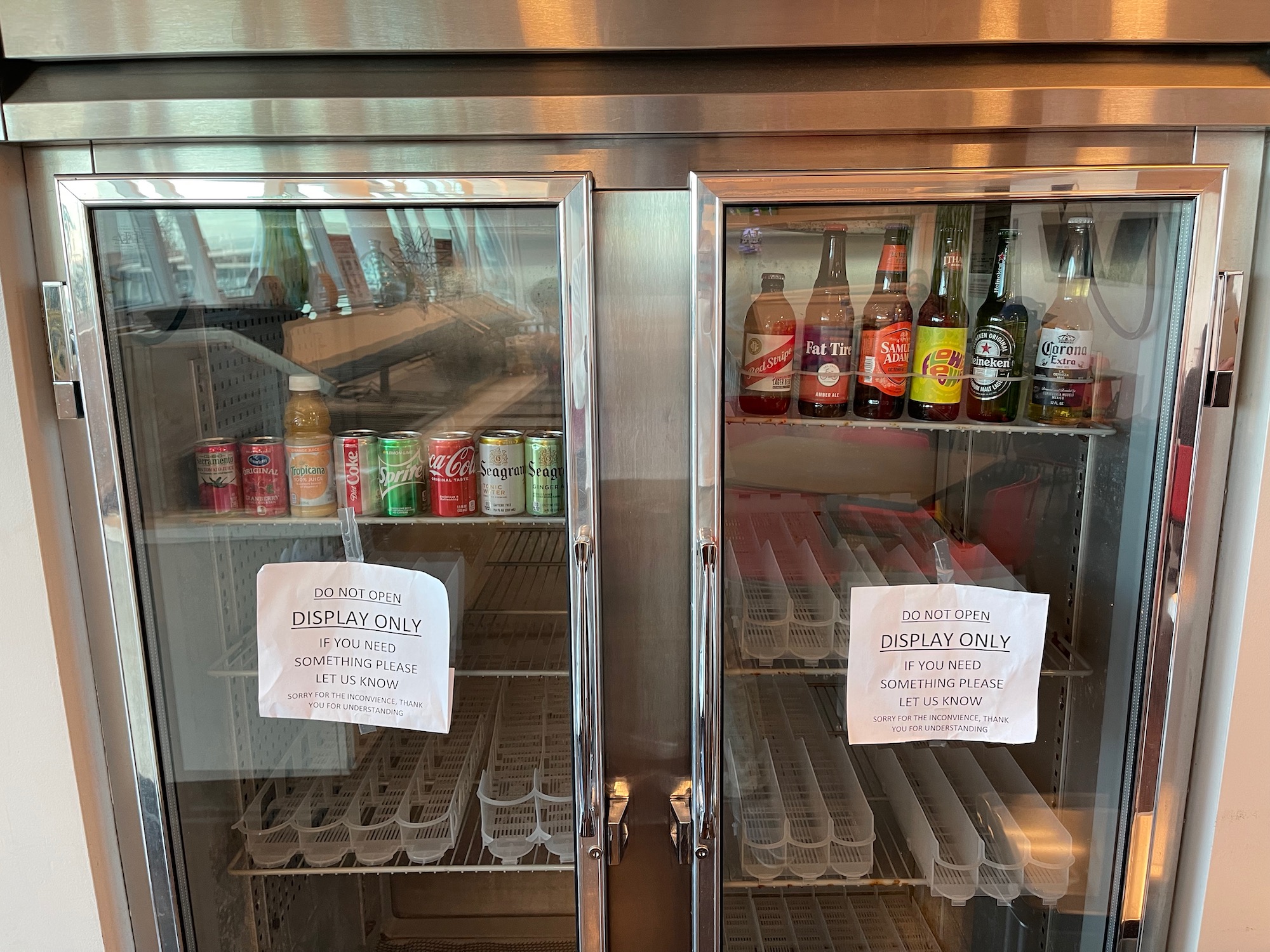 a refrigerator with drinks and signs