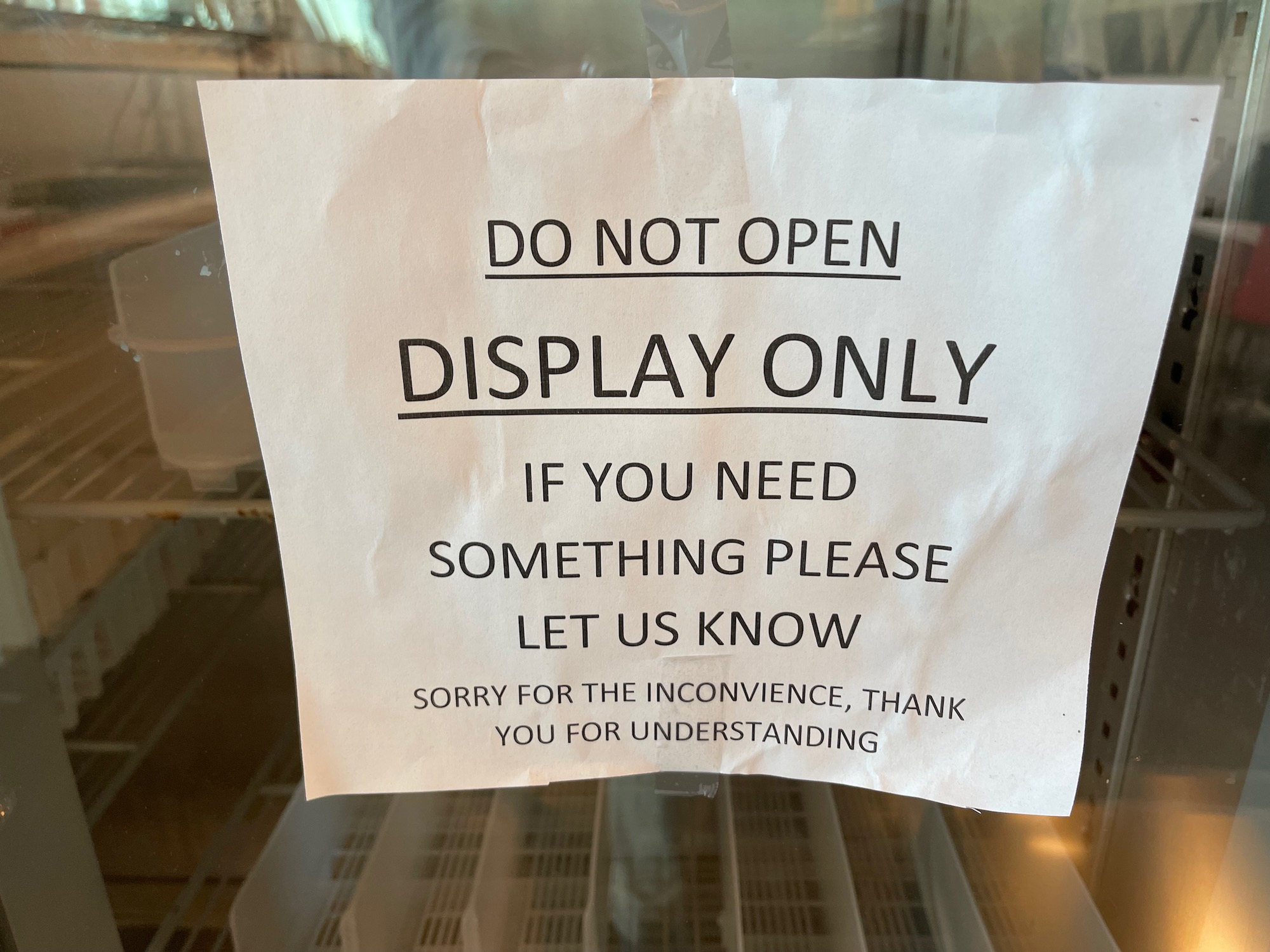 a sign on a glass shelf