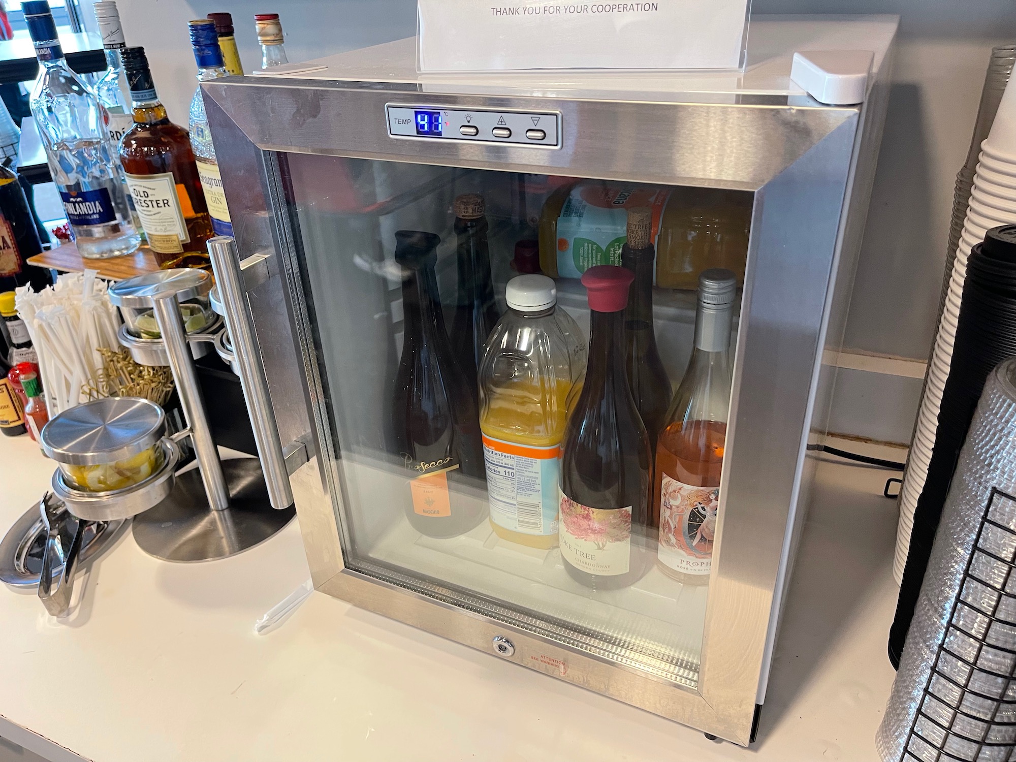 a small refrigerator with bottles inside