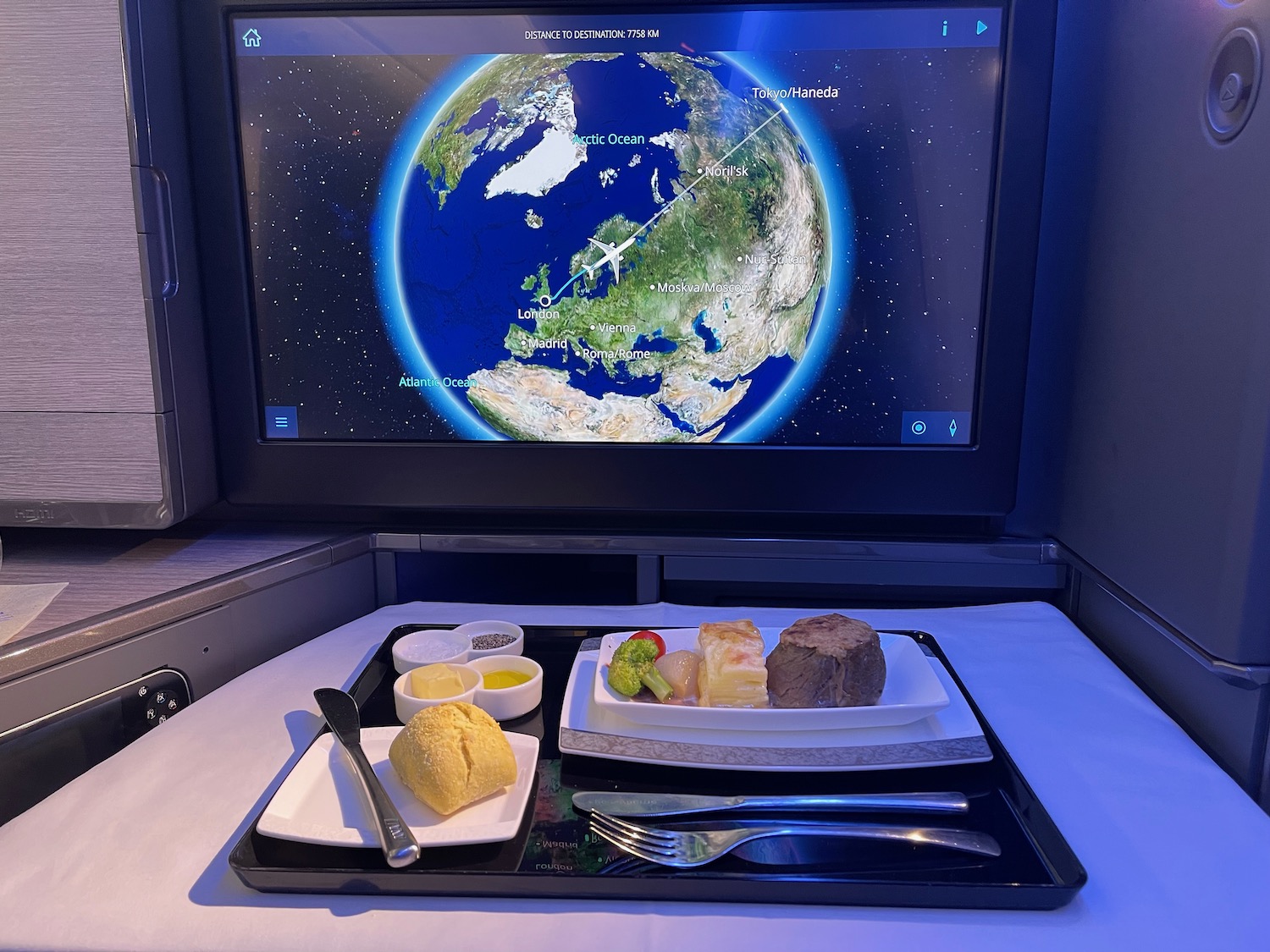 a tray of food on a table with a television screen