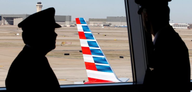 a man looking at an airplane tail