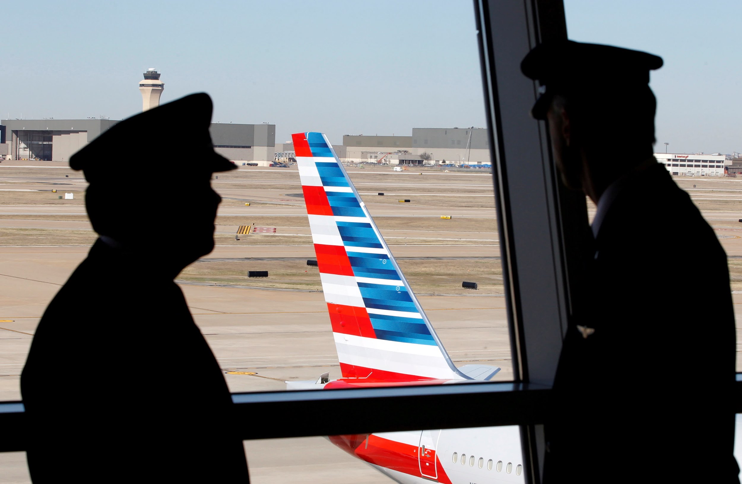 a man looking at an airplane tail