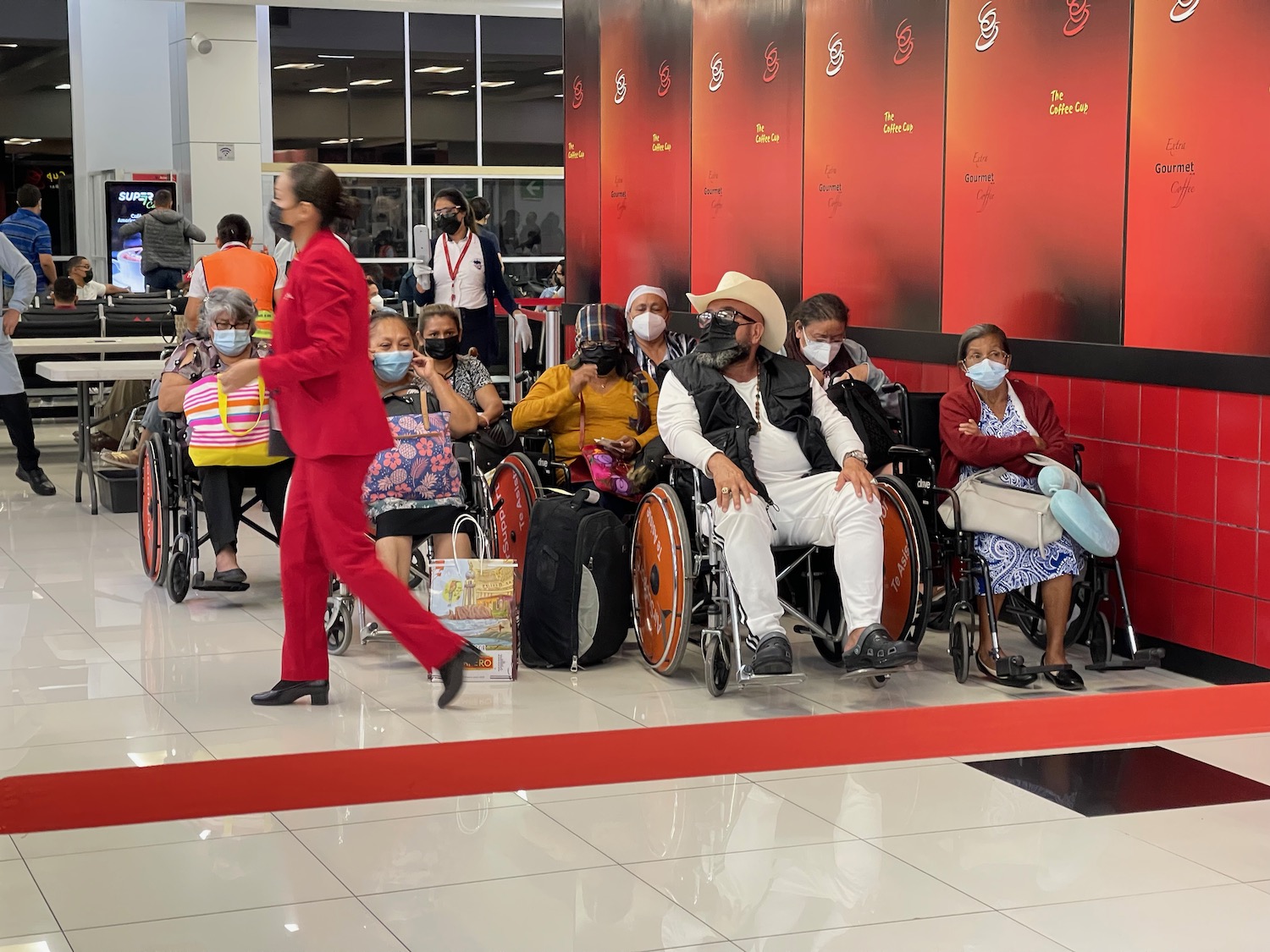 a group of people in wheelchairs with masks