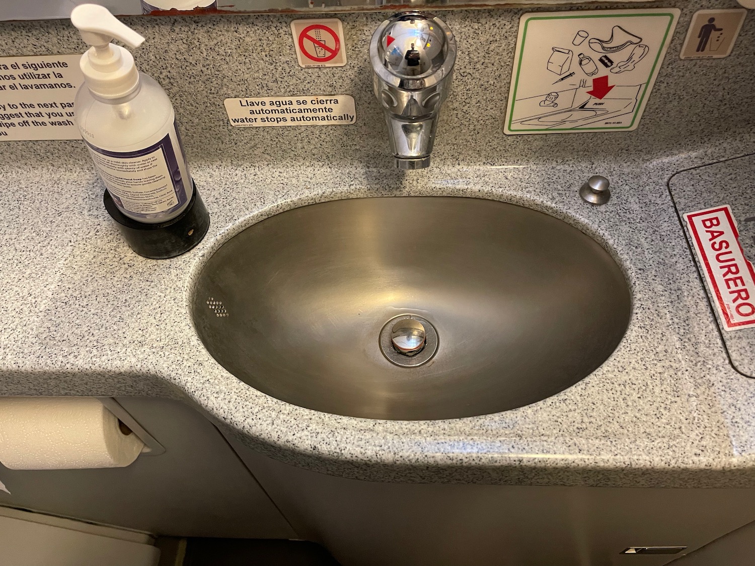 a sink with a bottle of soap and a label