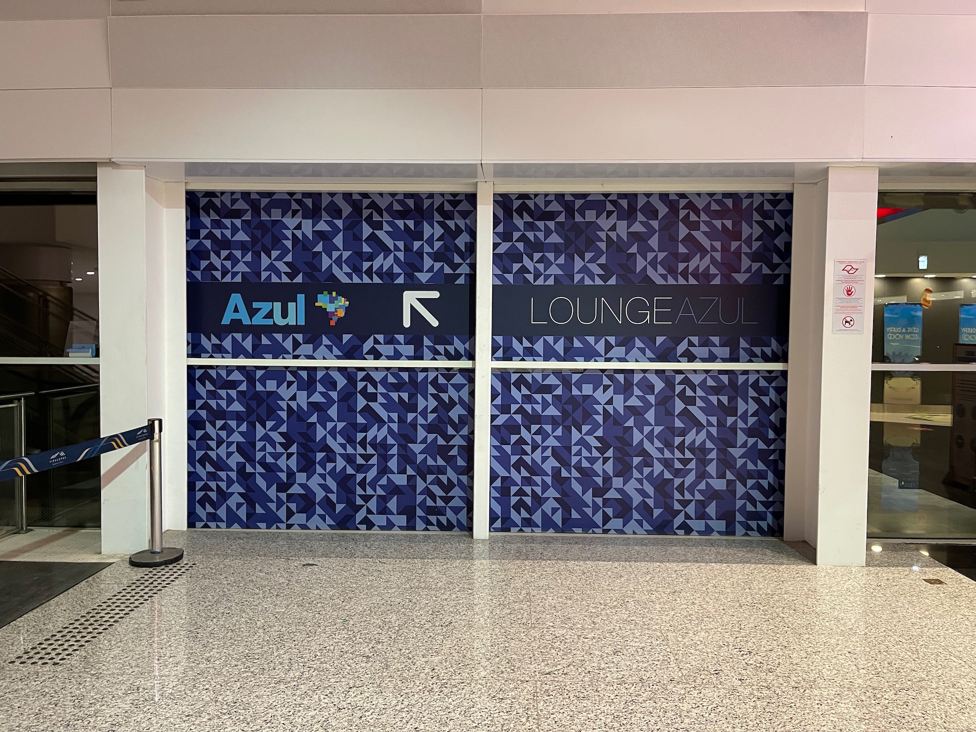 a blue and white patterned wall with signs on the side