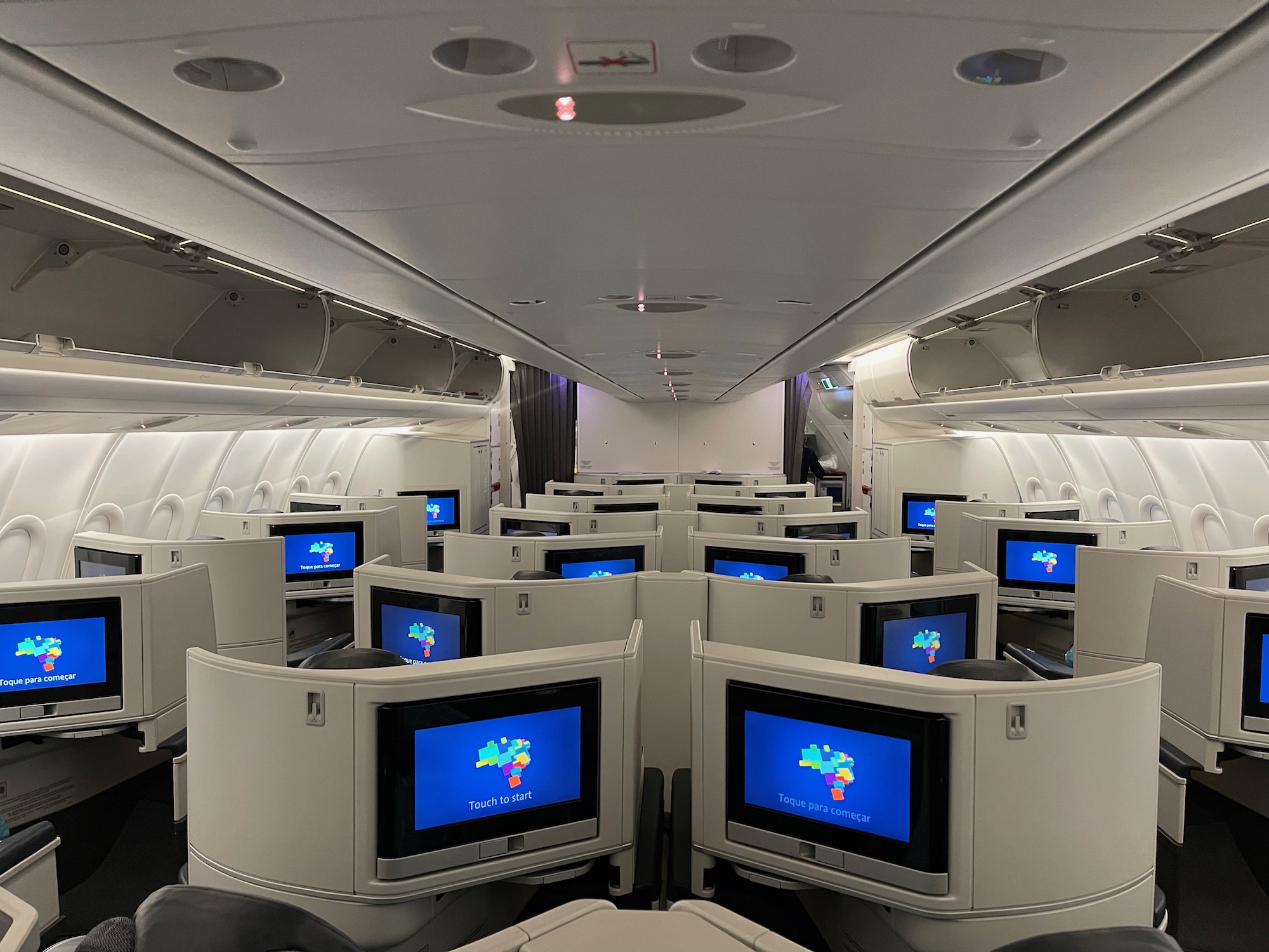 a row of monitors in an airplane