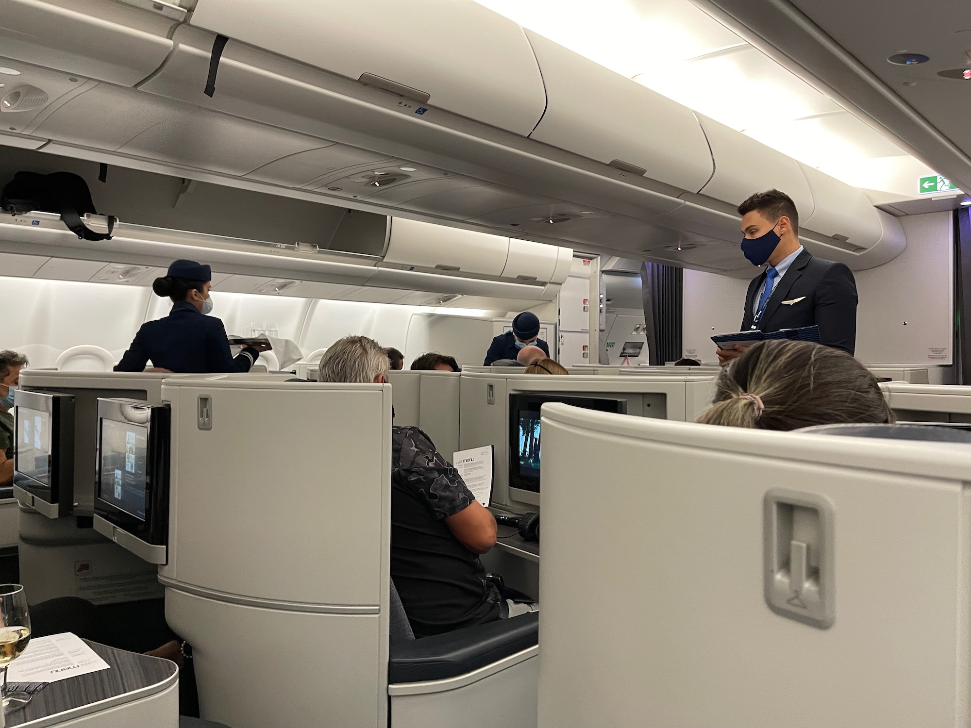 a man wearing a mask and sitting in an airplane