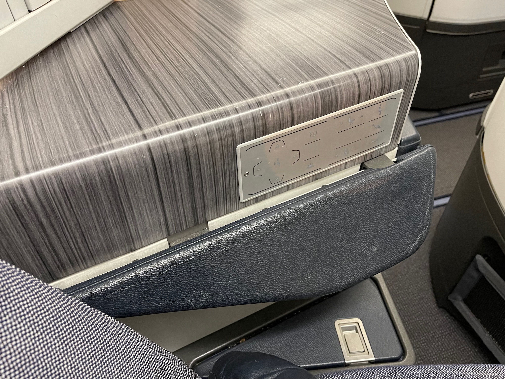 a seat with a seat belt and buttons