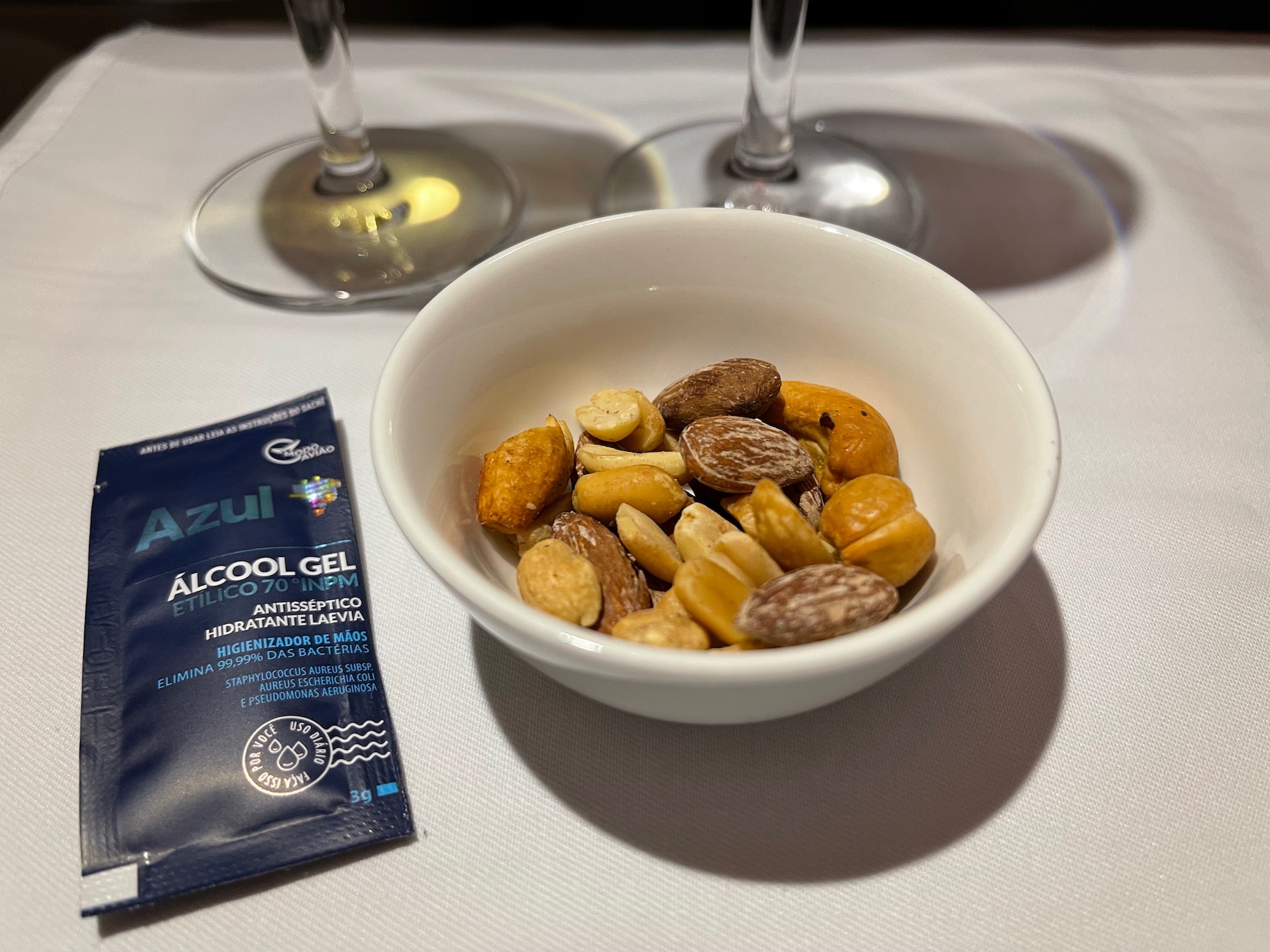a bowl of nuts and a packet of alcohol