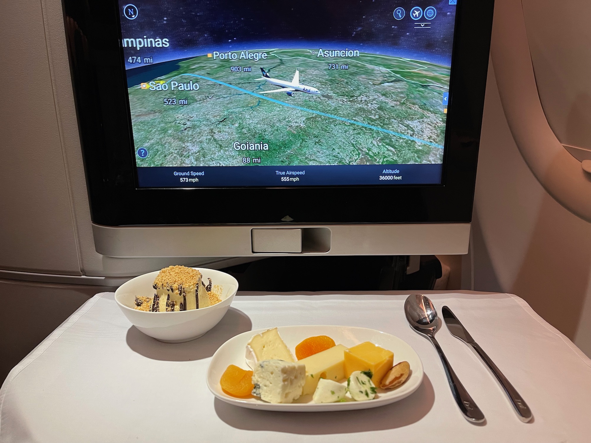 a plate of food on a table with a television