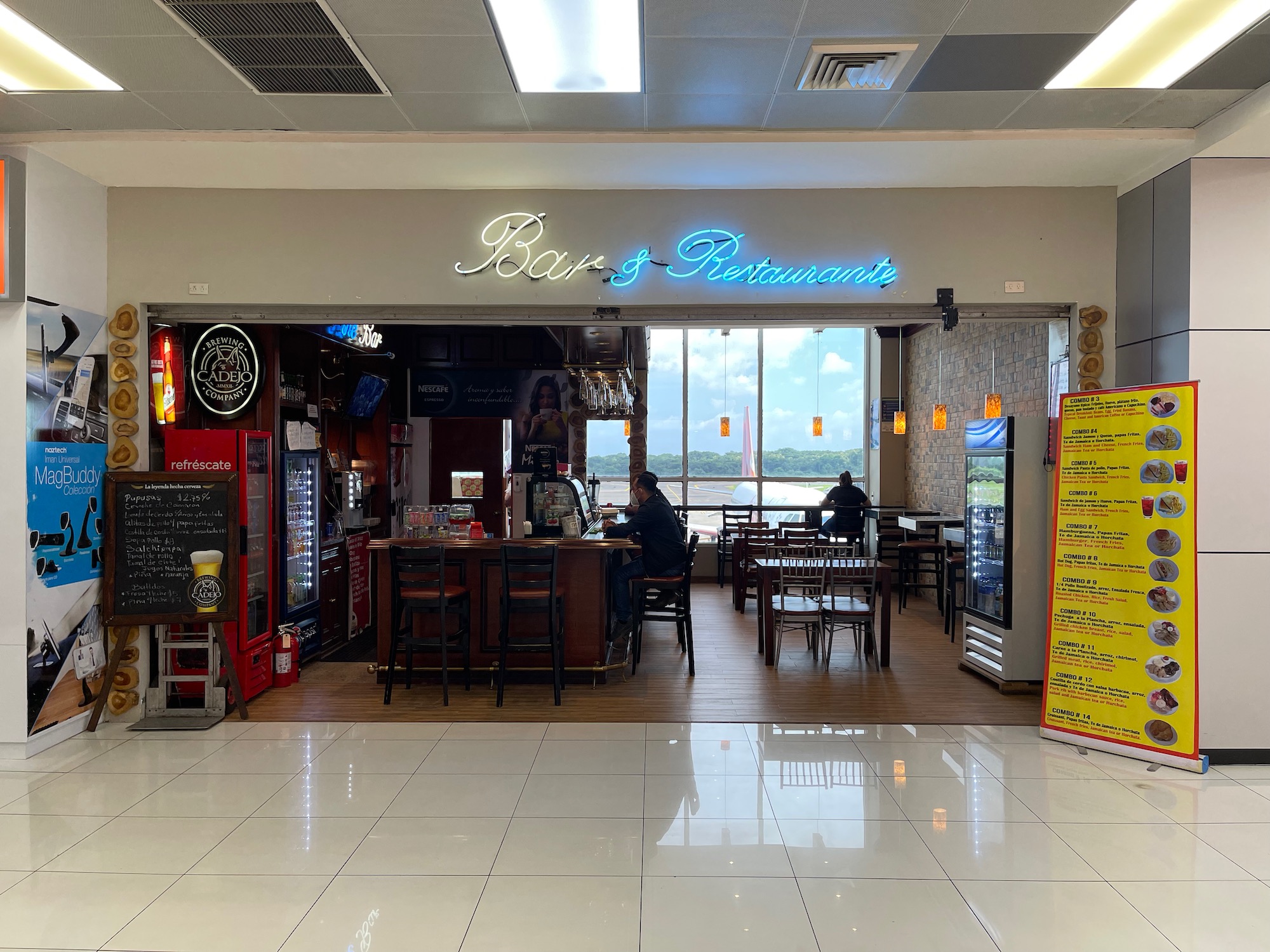 a restaurant with a man sitting at a table