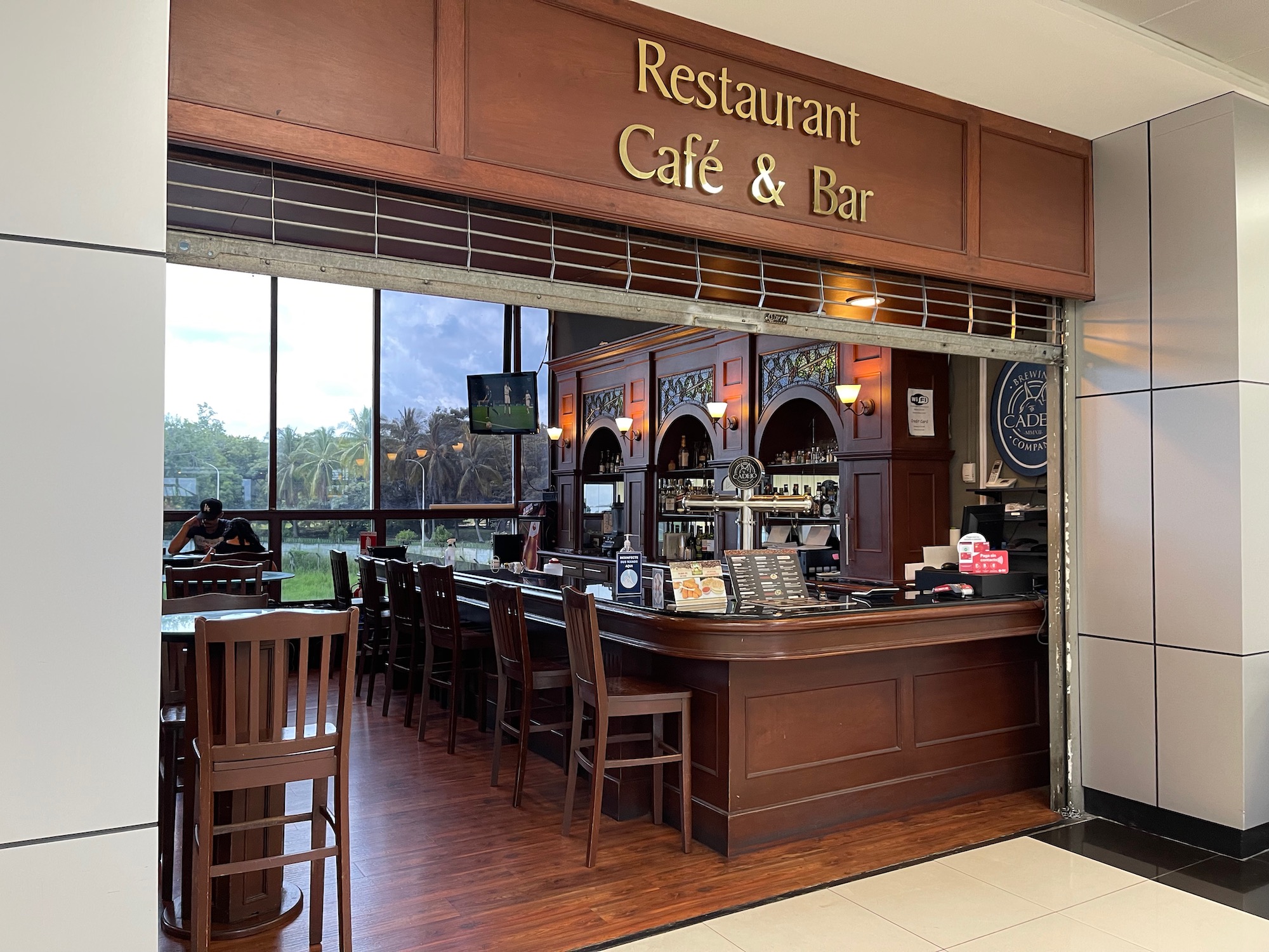 a restaurant with a bar and chairs