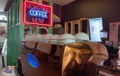 a coffee machine with a neon sign