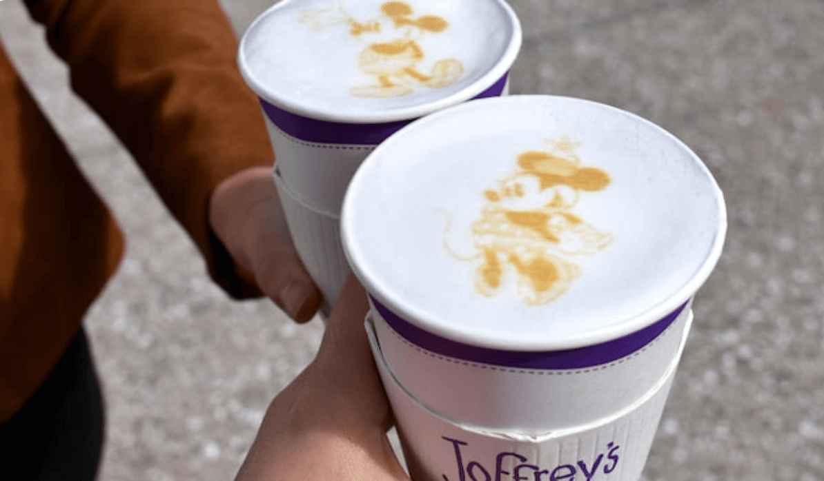 a person holding two cups of coffee