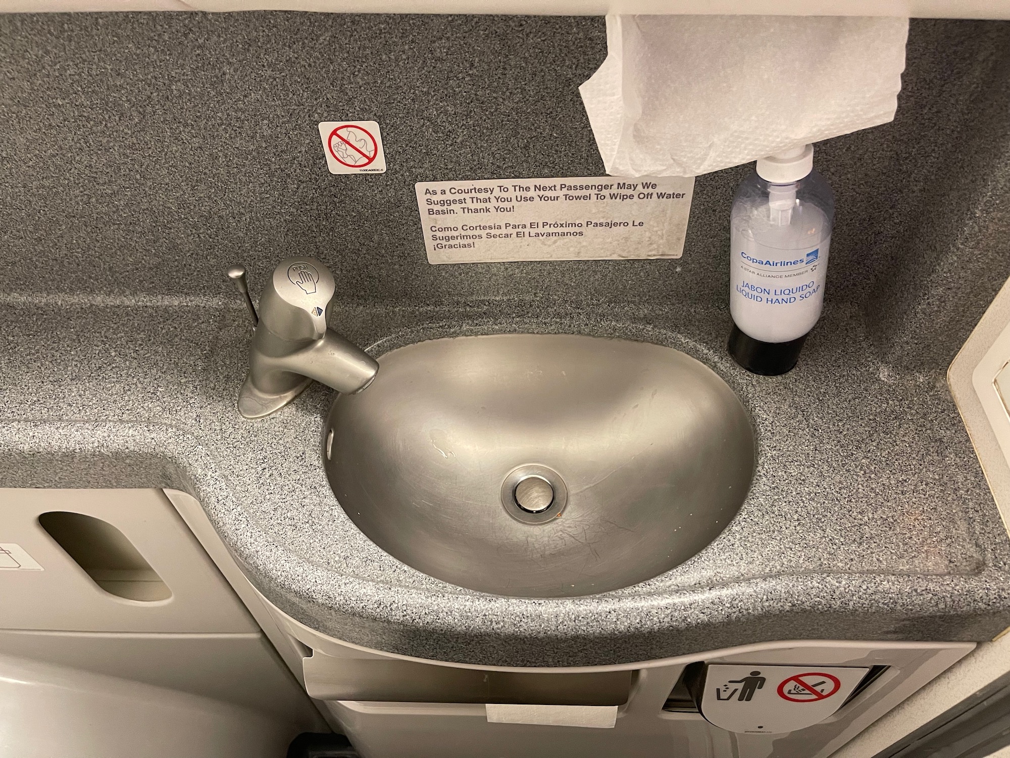 a sink with a bottle of liquid and a label on it