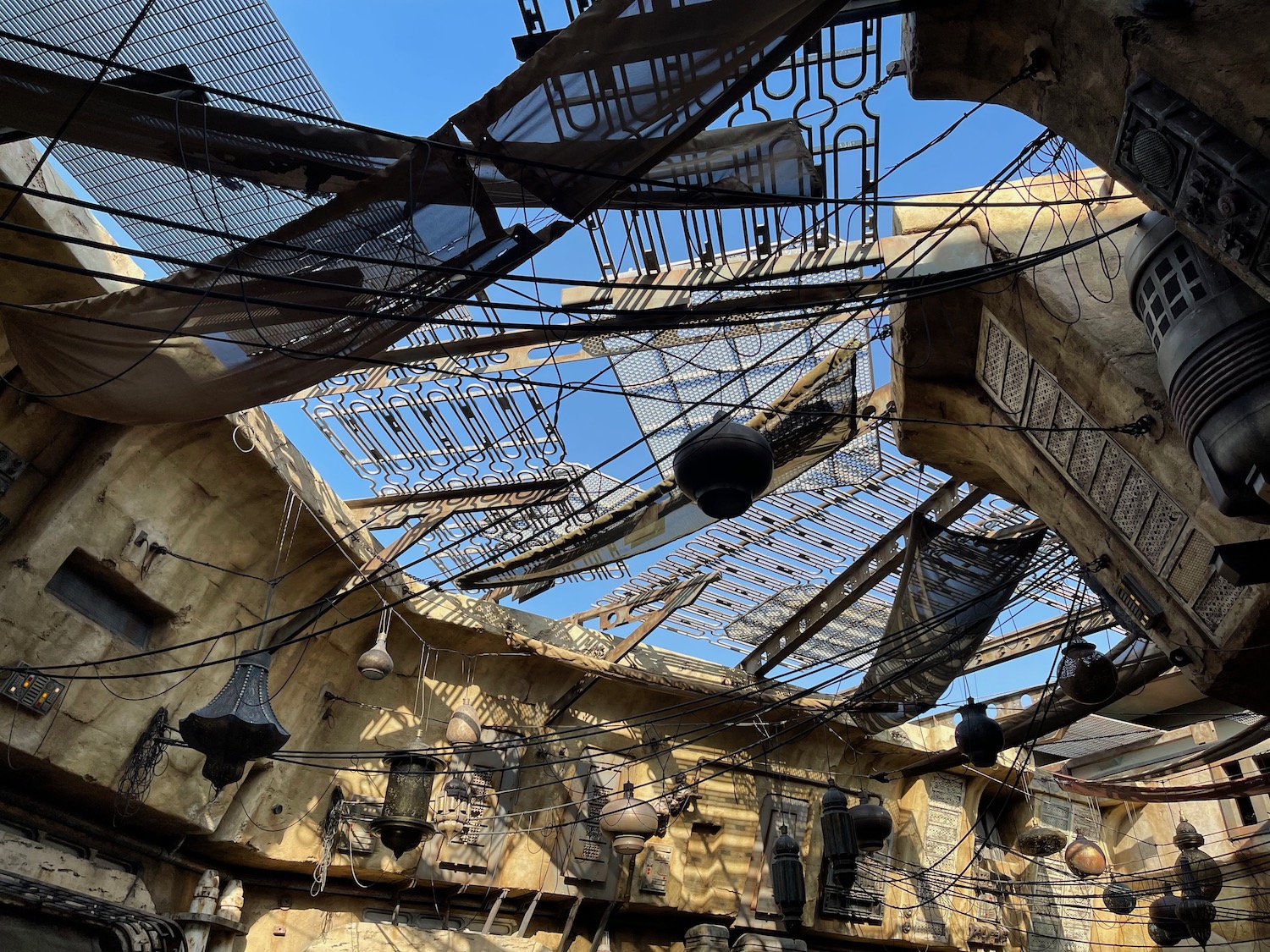 a ceiling of a building with a roof and wires