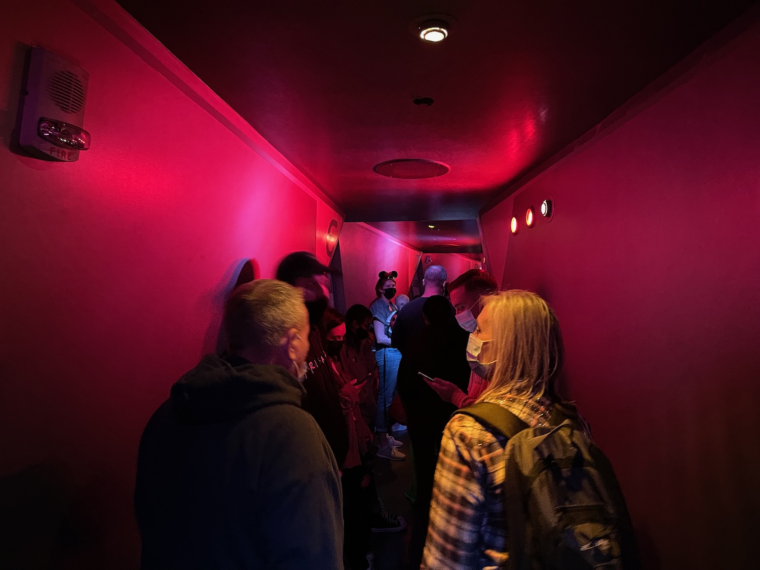 a group of people in a dark hallway