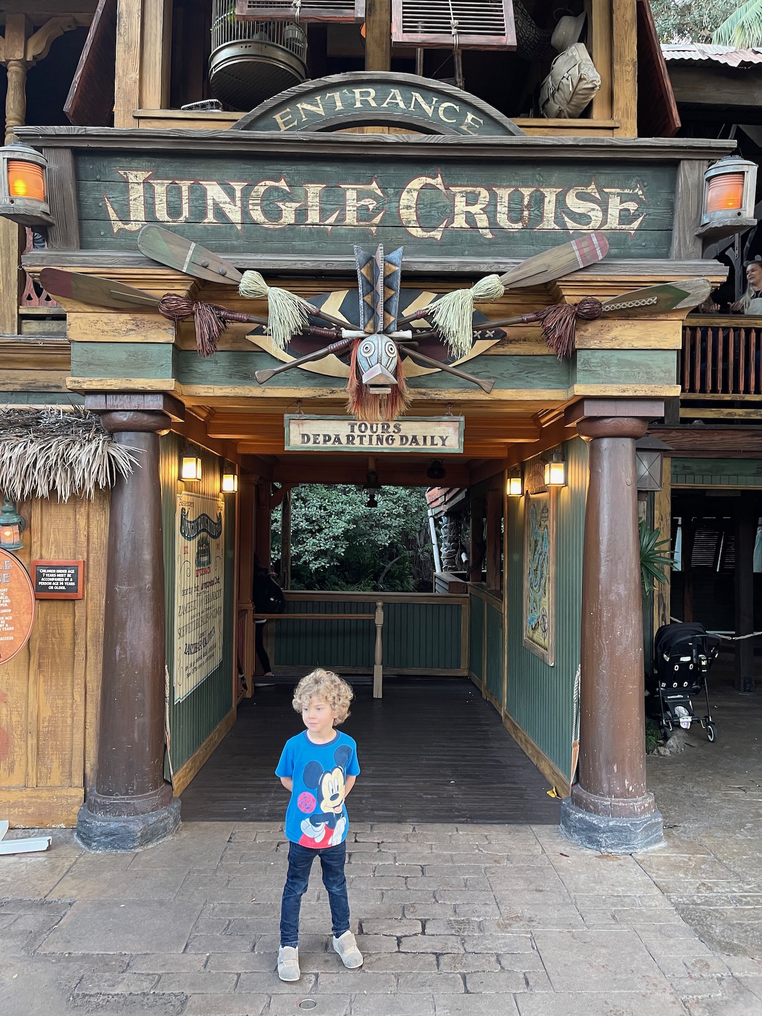 a child standing in front of a building