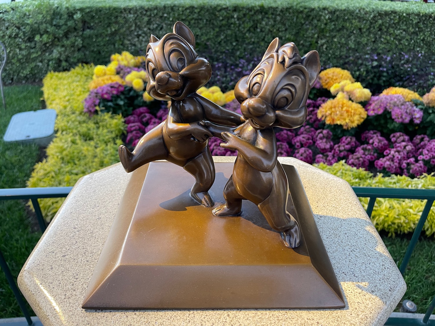 a statue of two squirrels on a pedestal