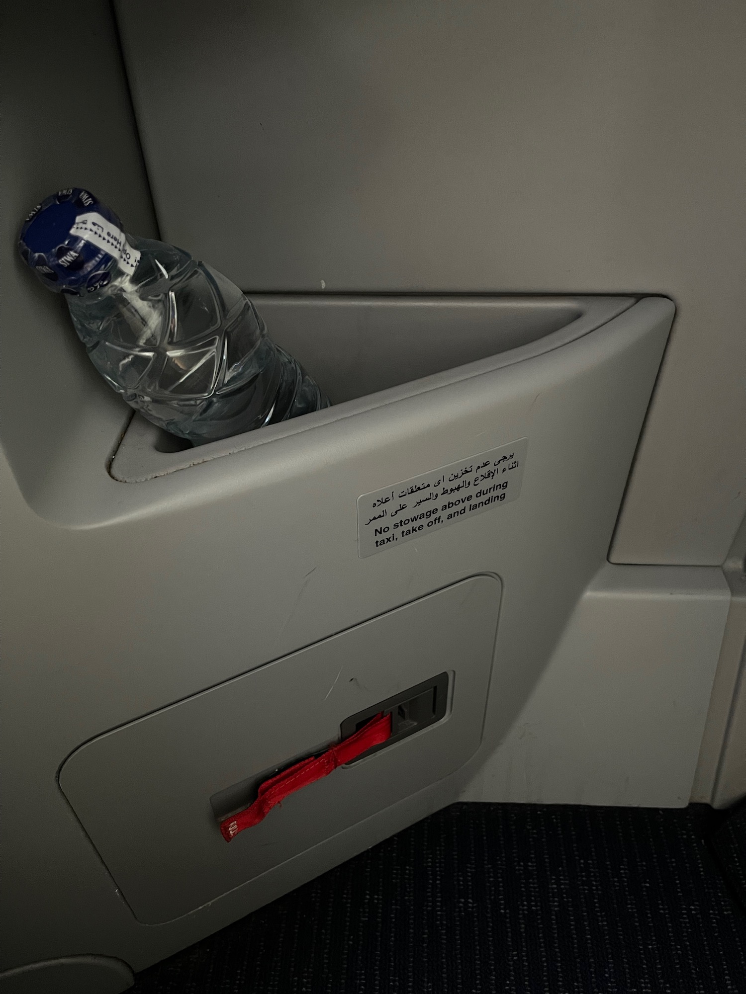 a bottle in a hole in a seat