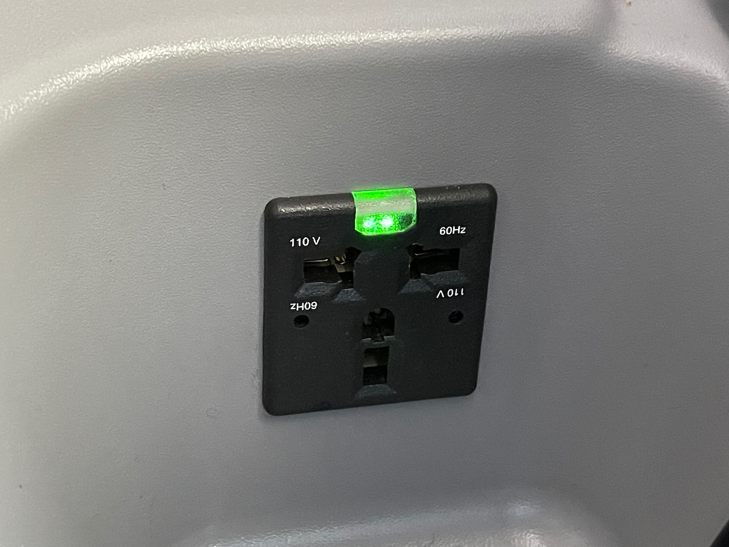 a black outlet with a green light