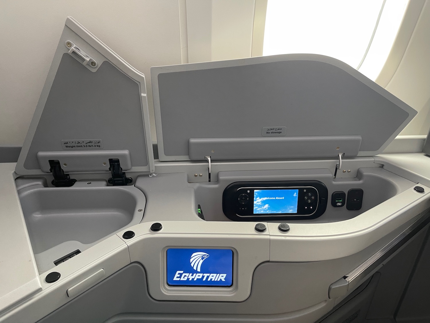 an airplane seat with a screen and a screen