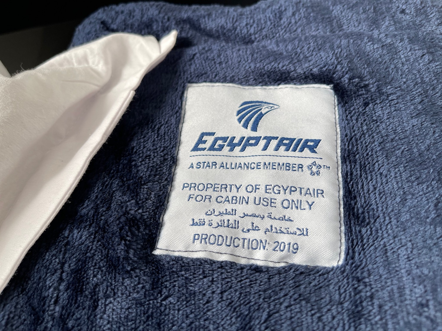 a blue towel with white text and a white glove