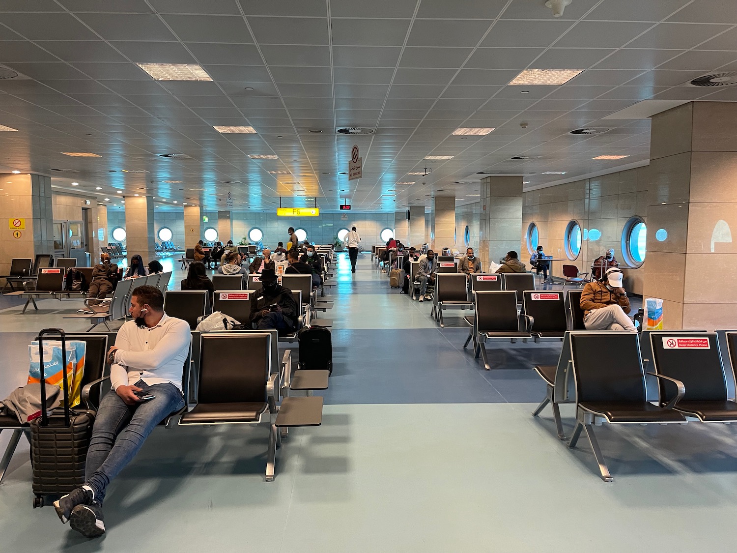 people sitting in chairs in a large room