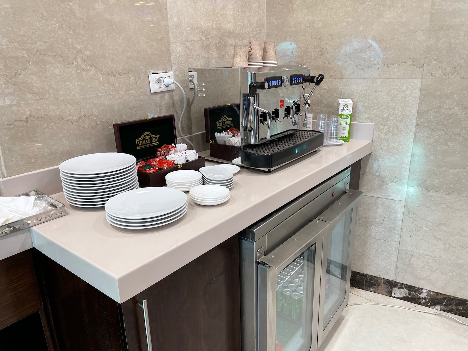 a coffee machine and plates on a counter