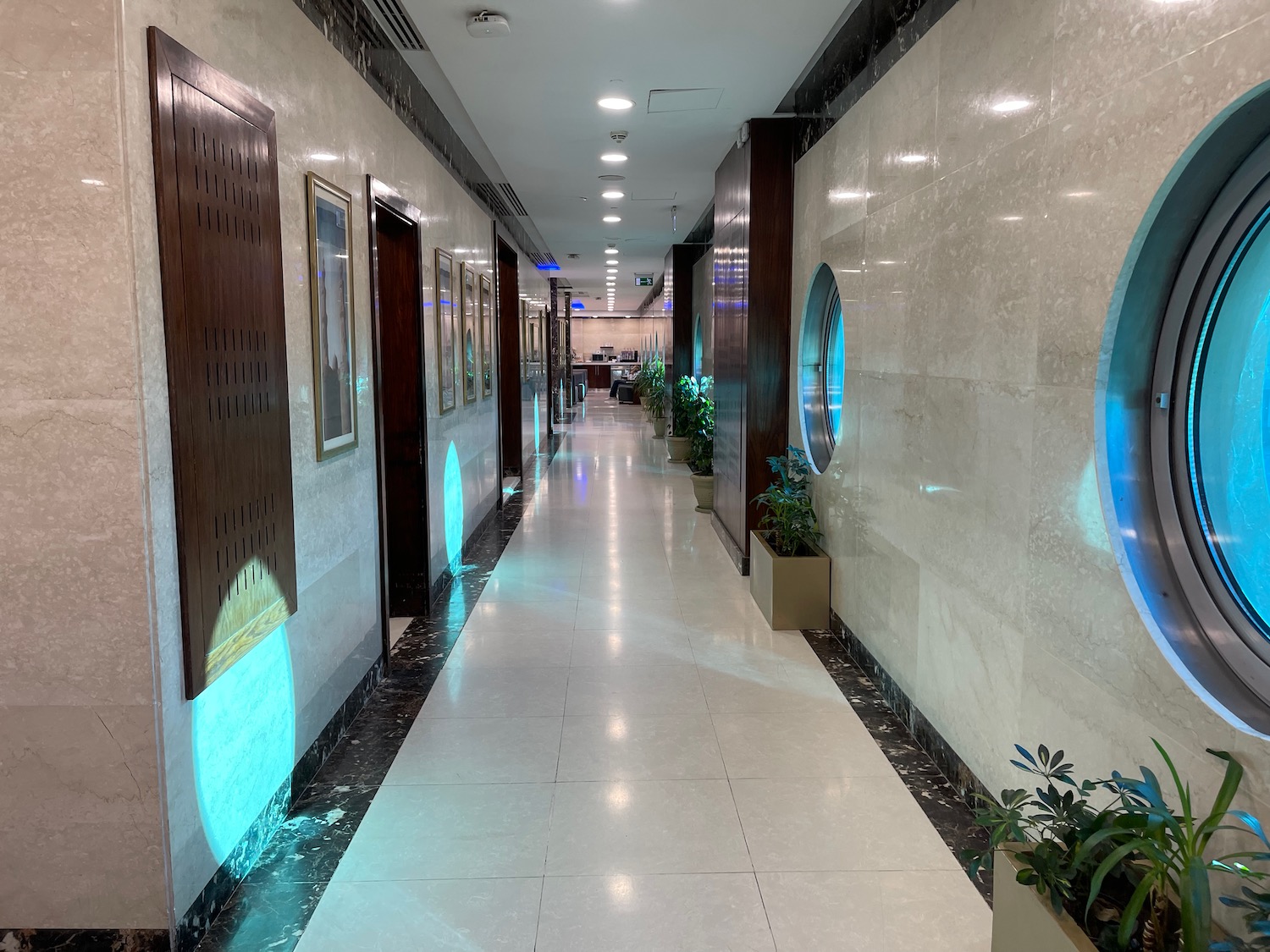 a hallway with a tile floor and a white tile floor