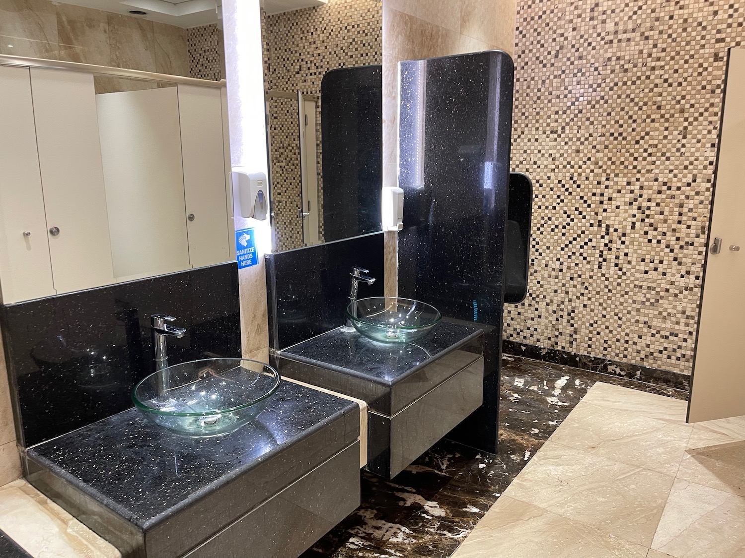 a bathroom with sinks and mirrors