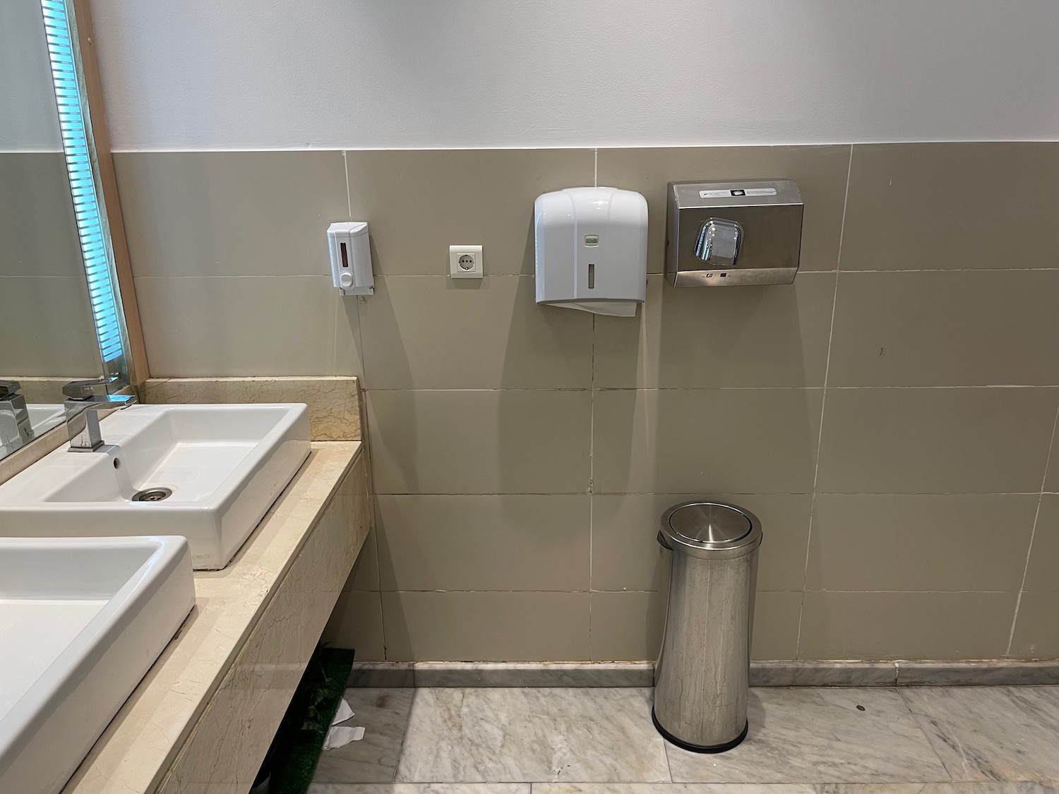 a bathroom with a sink and soap dispenser