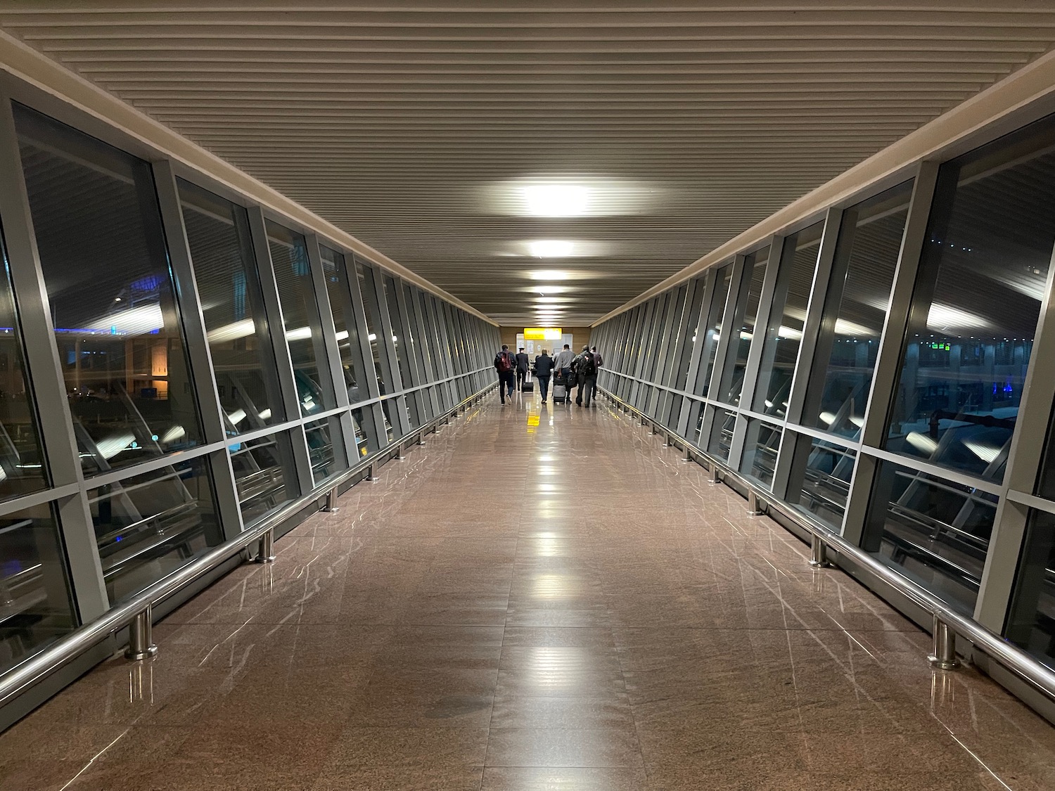 a group of people walking on a walkway